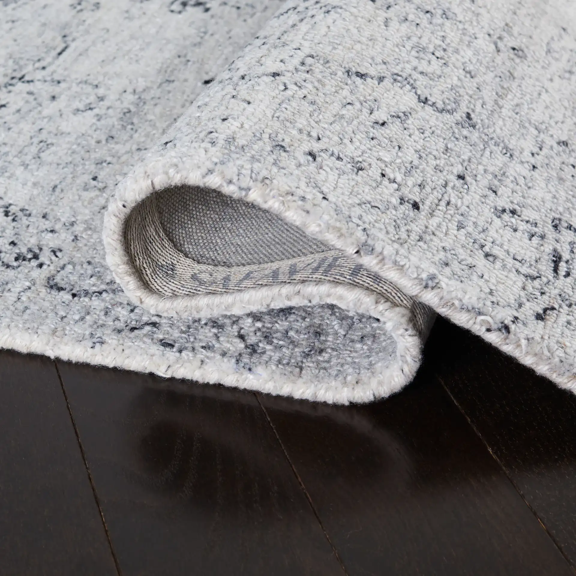 Abstract Transitional Medallion Hand-Tufted Rug in Ivory / Black in a styled room