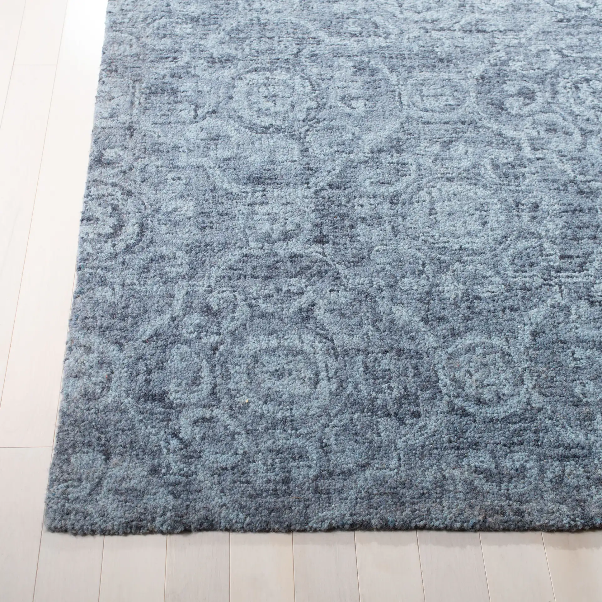 Abstract Transitional Allover Rosette Hand-Tufted Wool Rug in Blue in a styled room