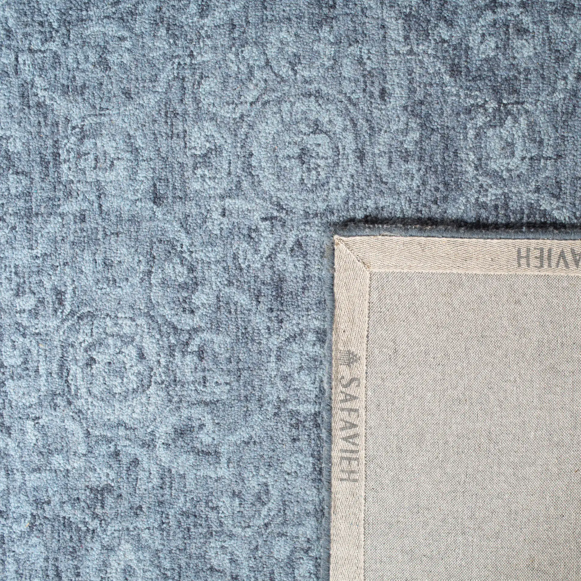 Abstract Transitional Allover Rosette Hand-Tufted Wool Rug in Blue in a styled room