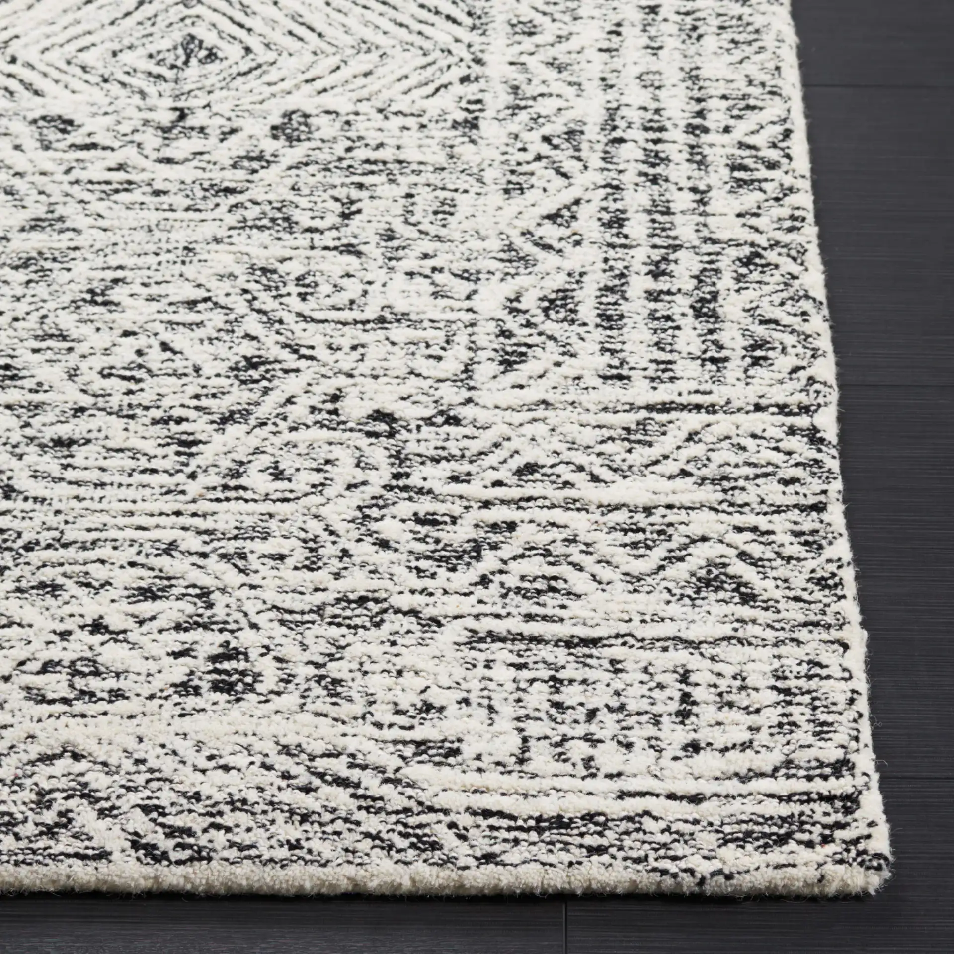 Abstract Boho Patchwork Hand-Tufted Wool Rug in Black / Ivory in a styled room