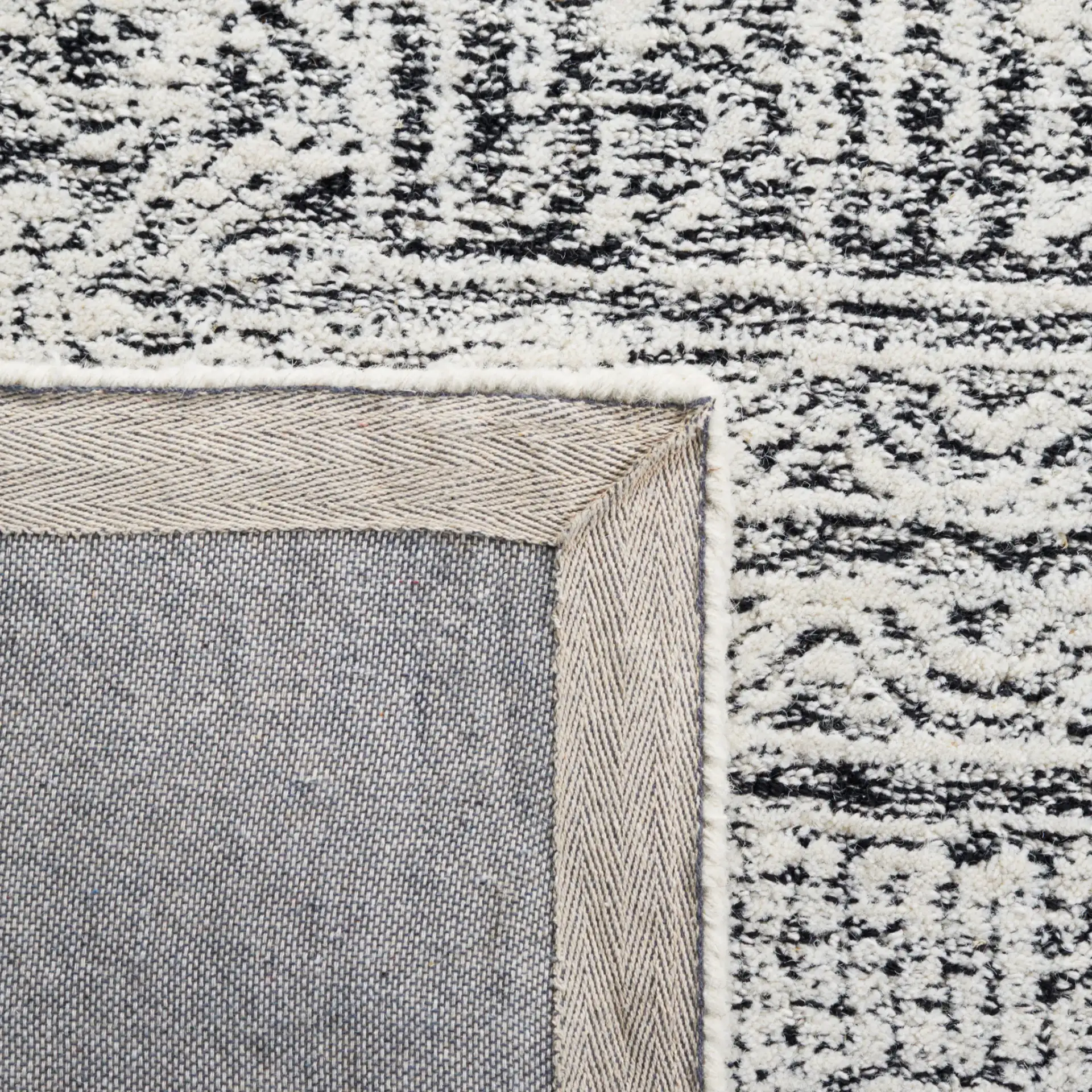 Abstract Boho Patchwork Hand-Tufted Wool Rug in Black / Ivory in a styled room