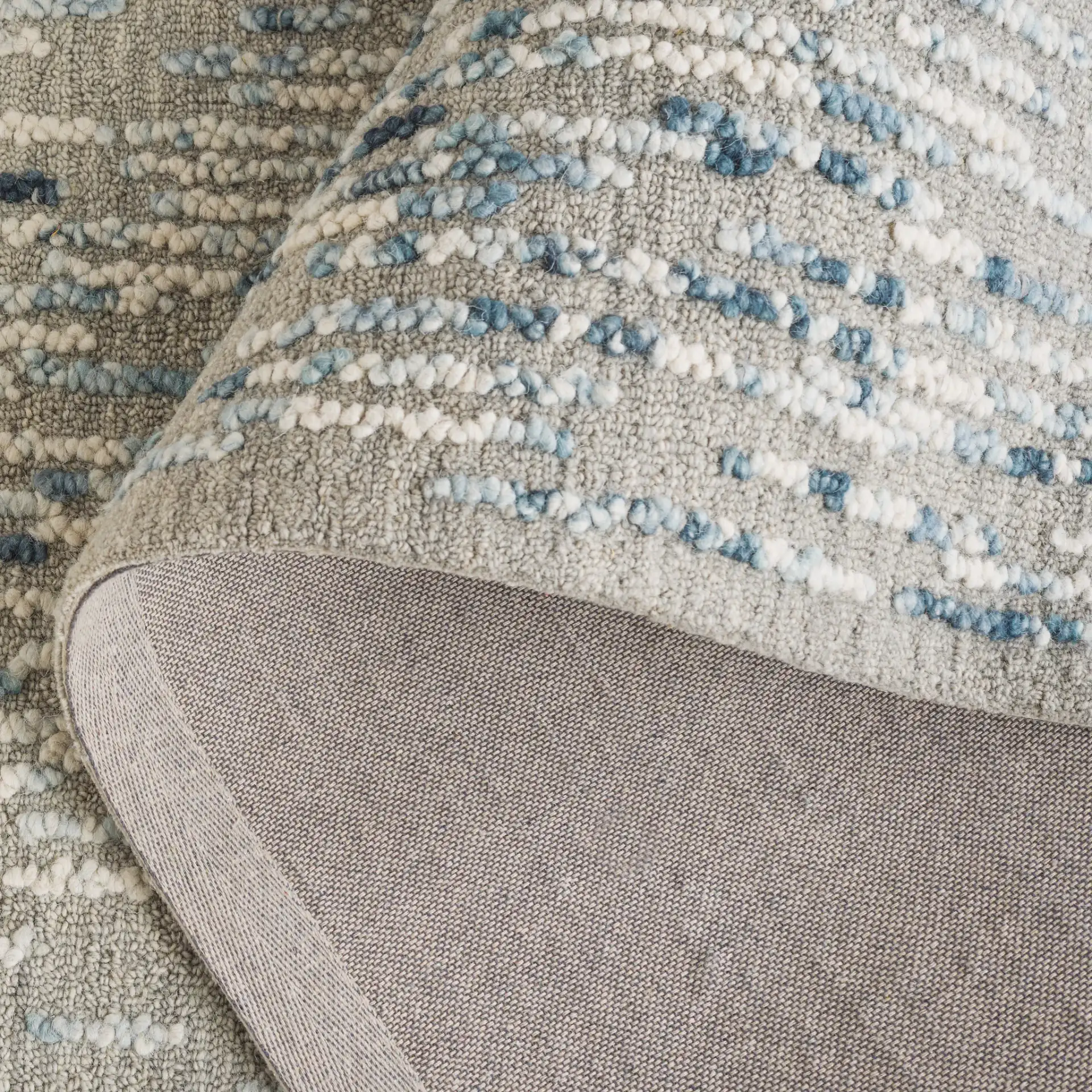 Abstract Dashed Stripe Hand-Tufted Wool Rug in Gray / Blue in a styled room