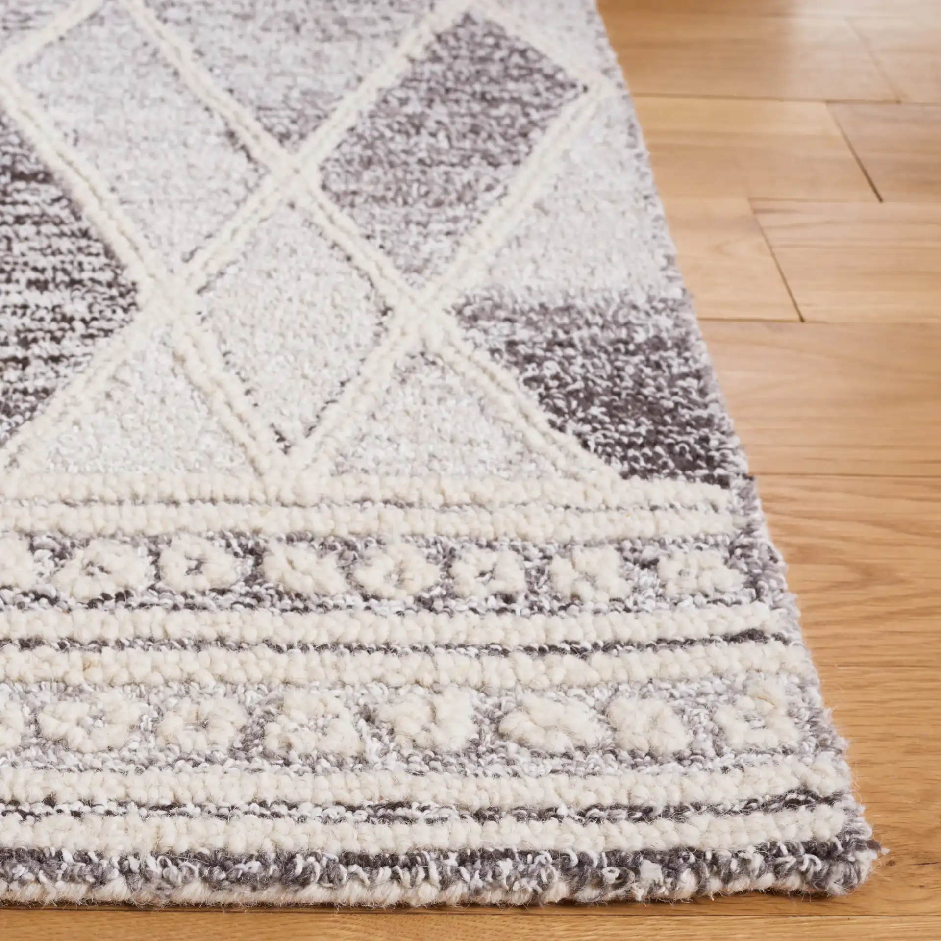 Abstract Boho Bordered Diamond Hand-Tufted Wool Rug in Ivory / Gray in a styled room