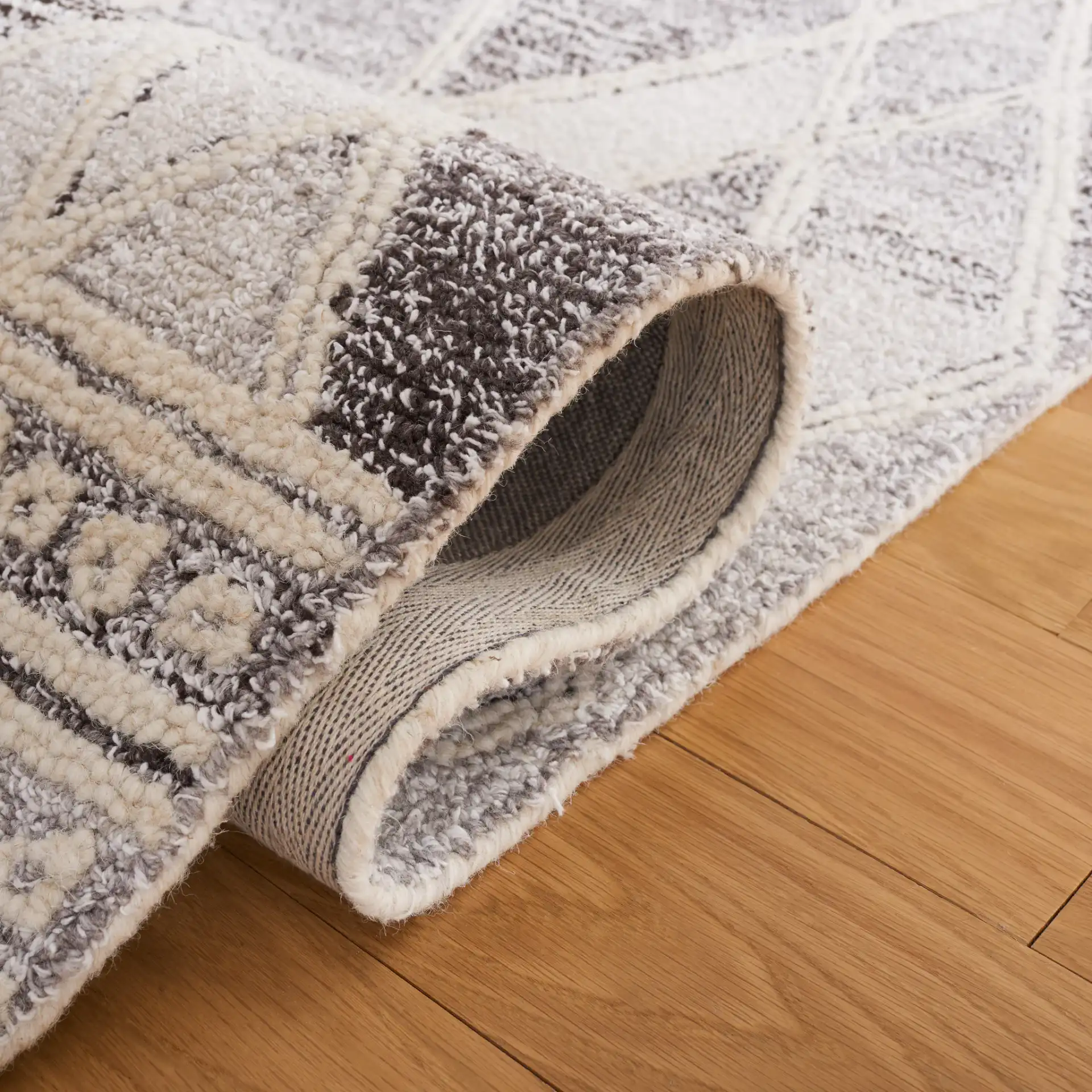 Abstract Boho Bordered Diamond Hand-Tufted Wool Rug in Ivory / Gray in a styled room