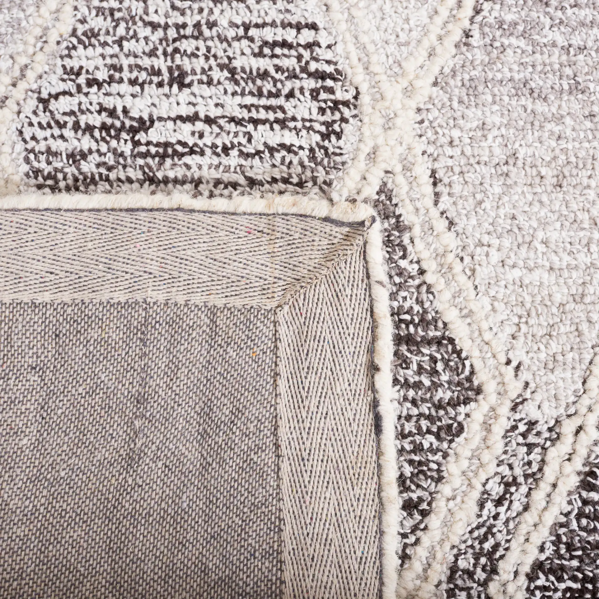 Abstract Boho Bordered Diamond Hand-Tufted Wool Rug in Ivory / Gray in a styled room