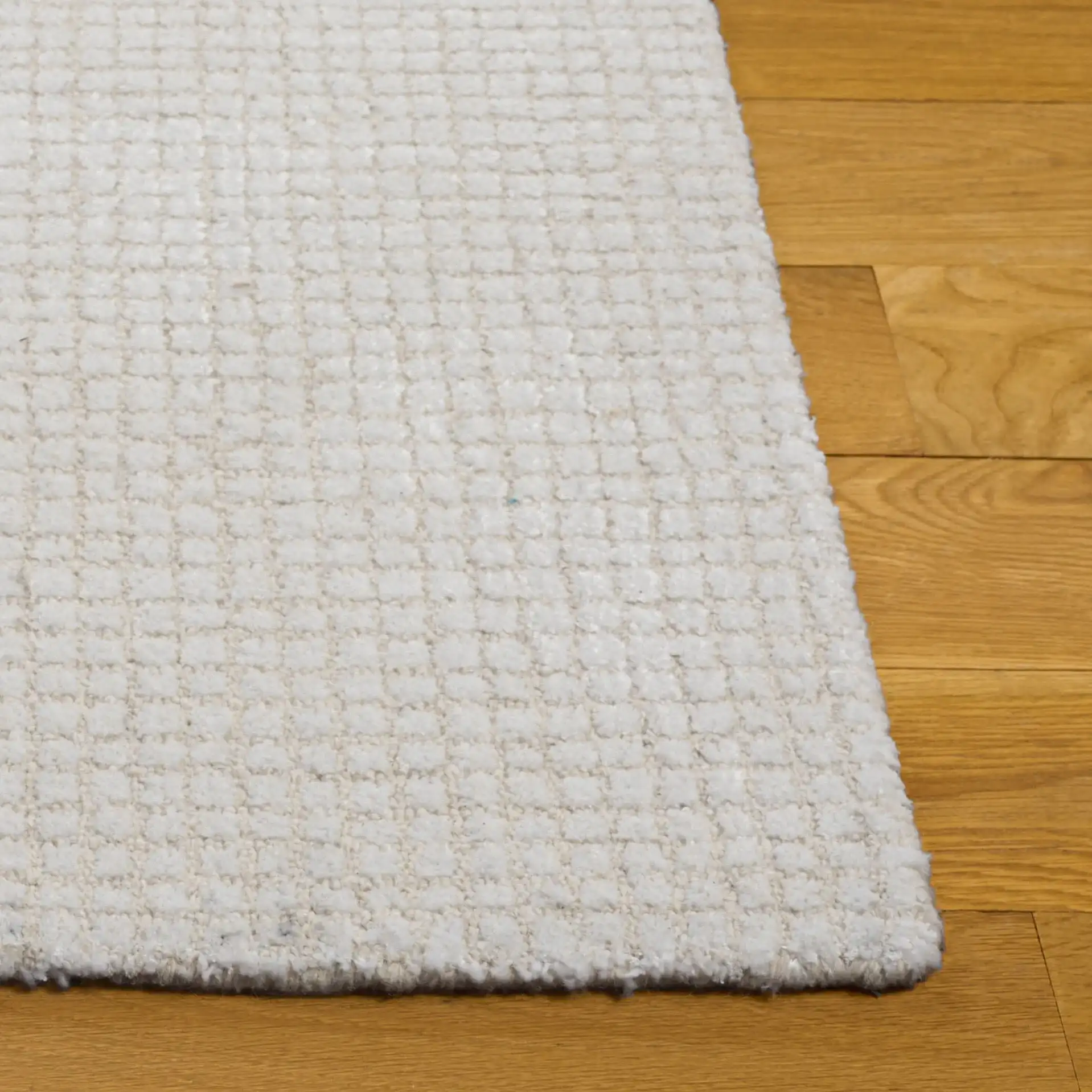 Abstract Solid Grid Hand-Tufted Rug in Ivory in a styled room