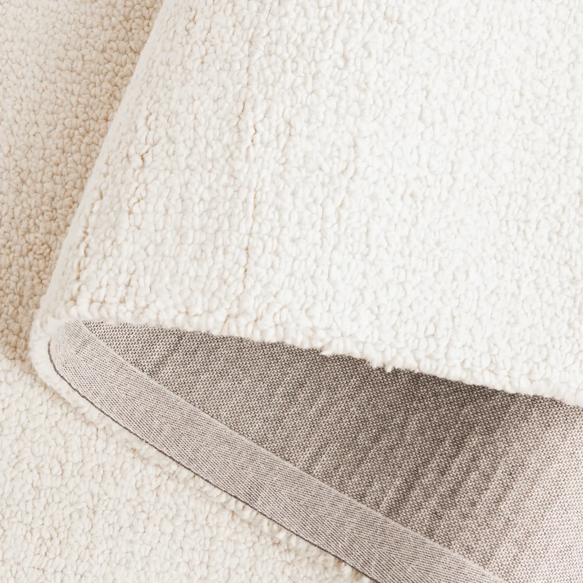 Abstract Modern Textured Solid Hand-Tufted Wool Rug in Ivory in a styled room
