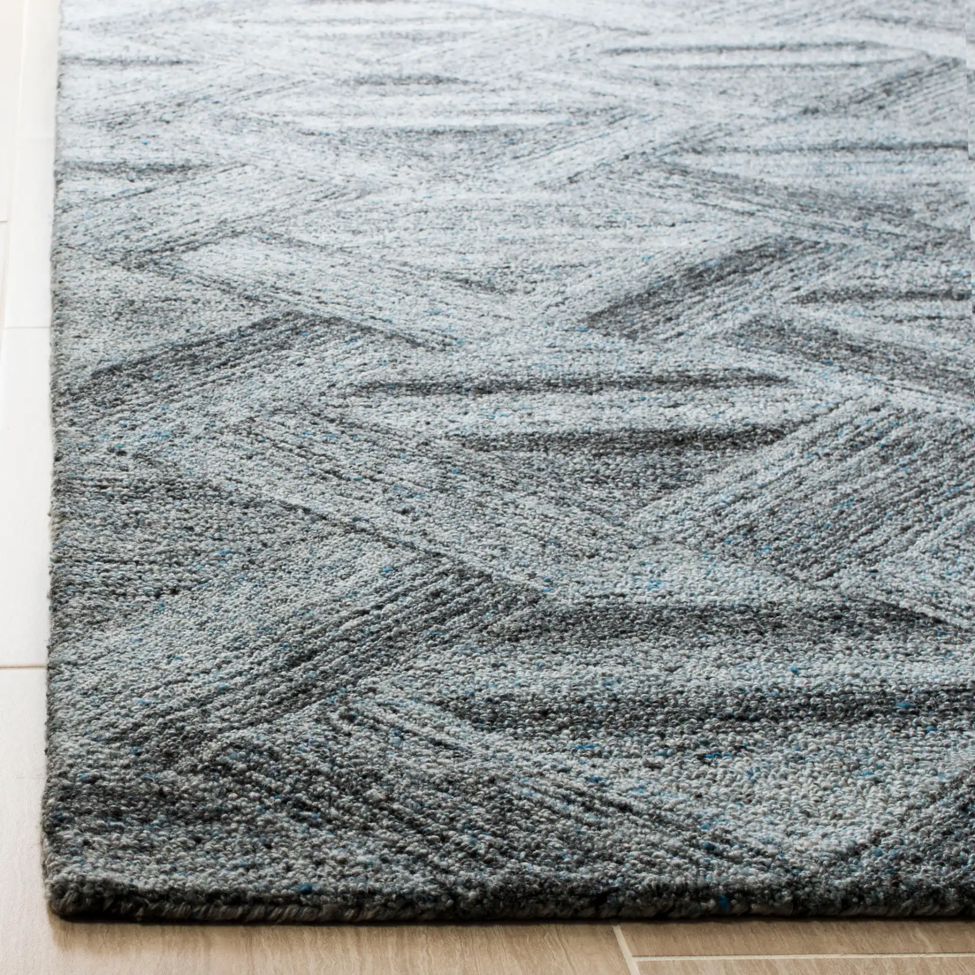 Abstract Triangle Hand-Tufted Wool Blend Rug in Blue / Black in a styled room
