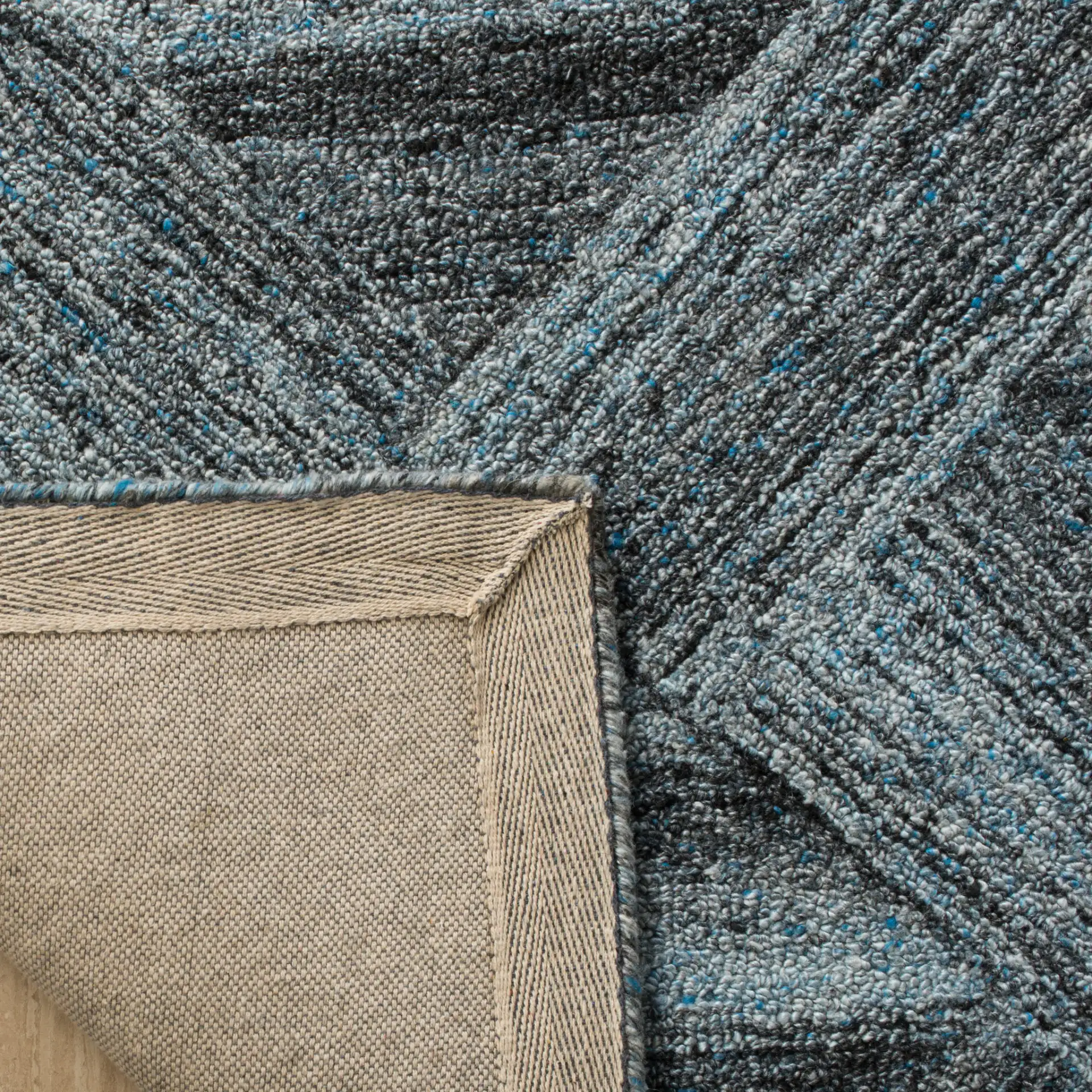 Abstract Triangle Hand-Tufted Wool Blend Rug in Blue / Black in a styled room
