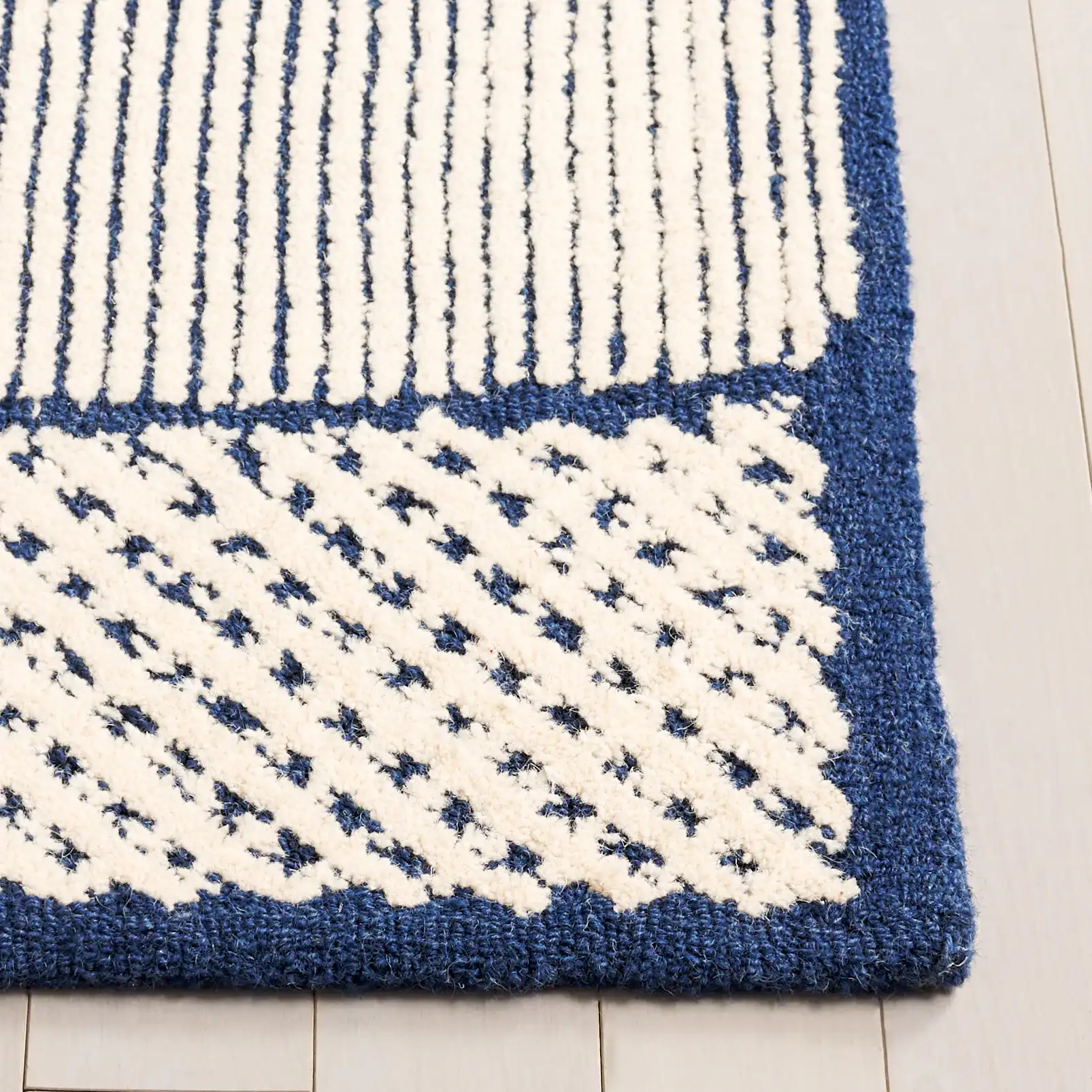 Abstract Patchwork Hand-Tufted Wool Rug in Ivory / Navy in a styled room