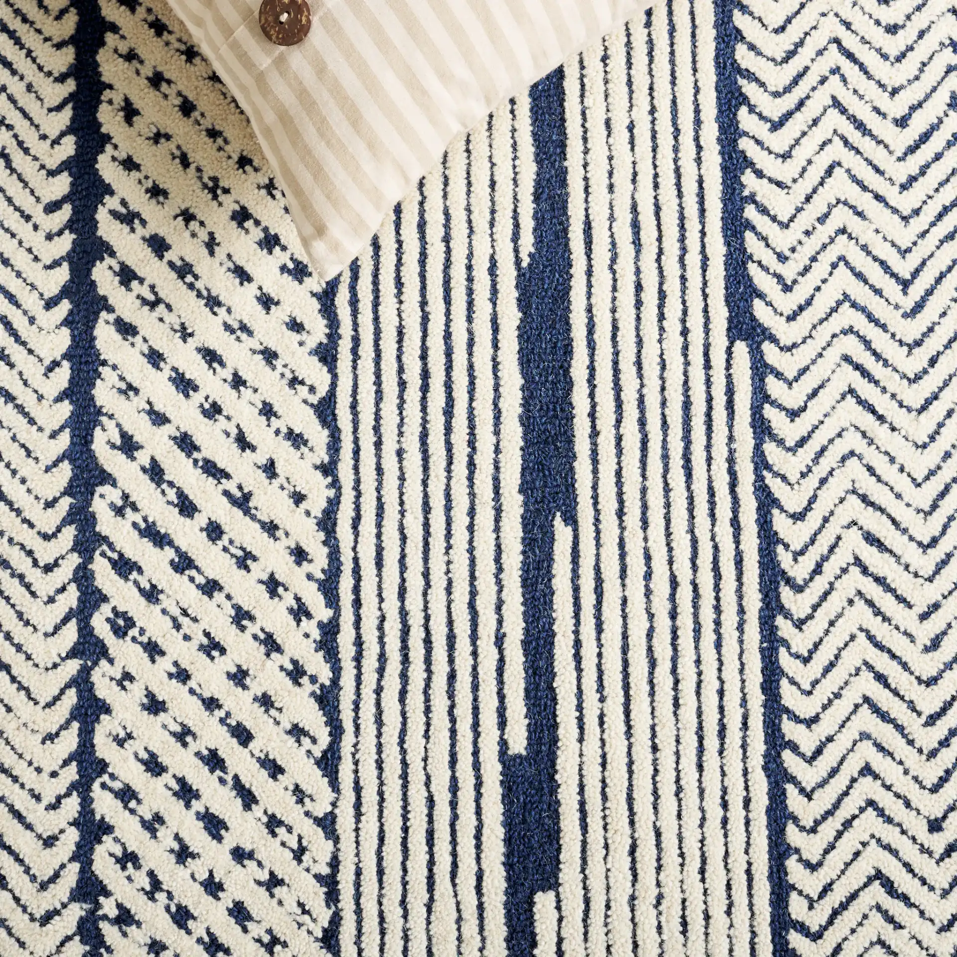 Abstract Patchwork Hand-Tufted Wool Rug in Ivory / Navy in a styled room