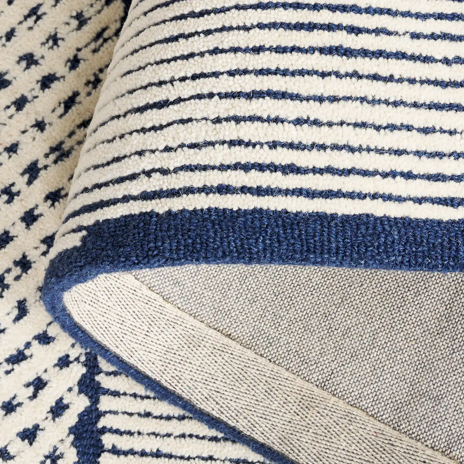 Abstract Patchwork Hand-Tufted Wool Rug in Ivory / Navy in a styled room