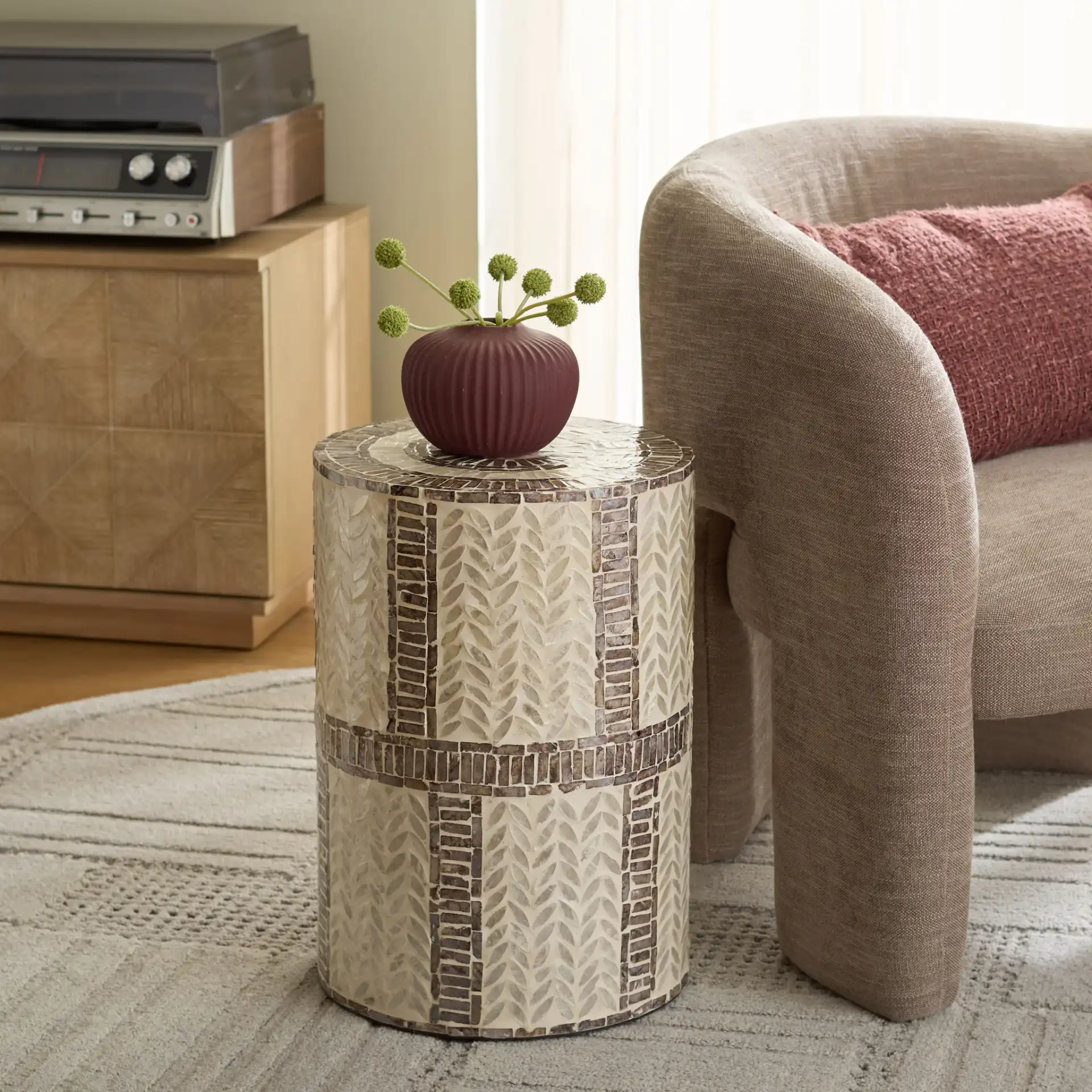 Keary Round Accent Table in White / Gold in a styled room