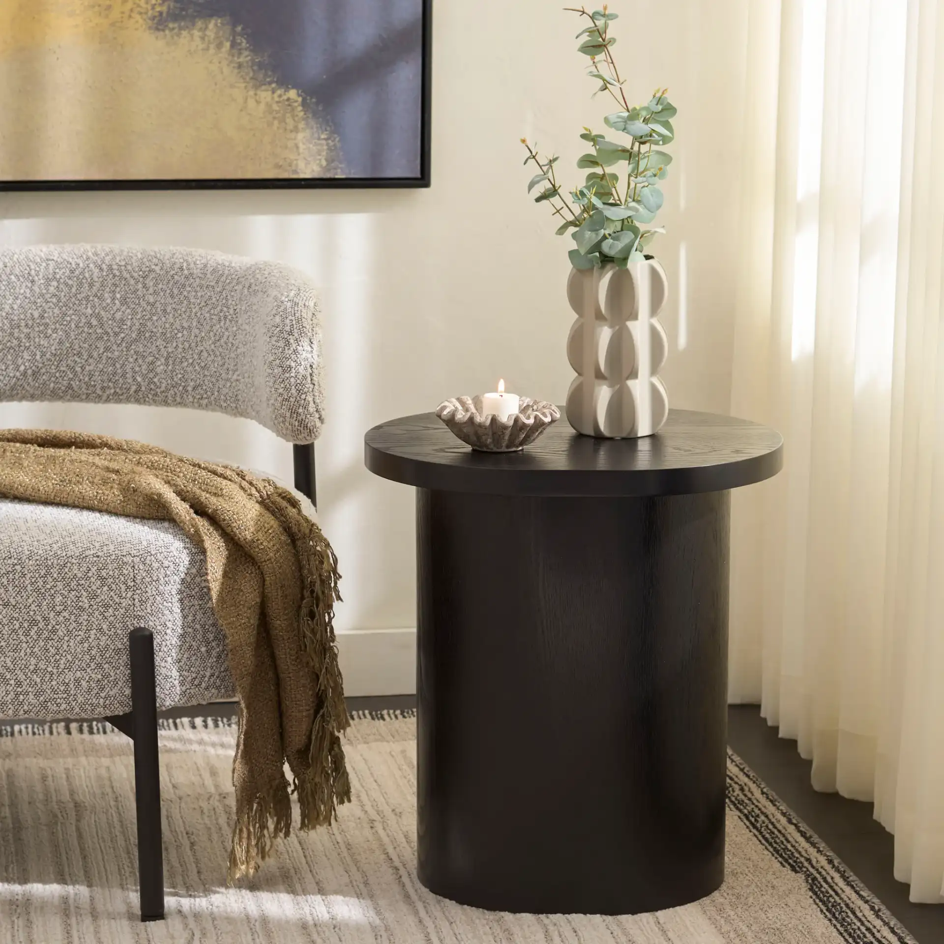 Ekon Round End Table in Black in a styled room