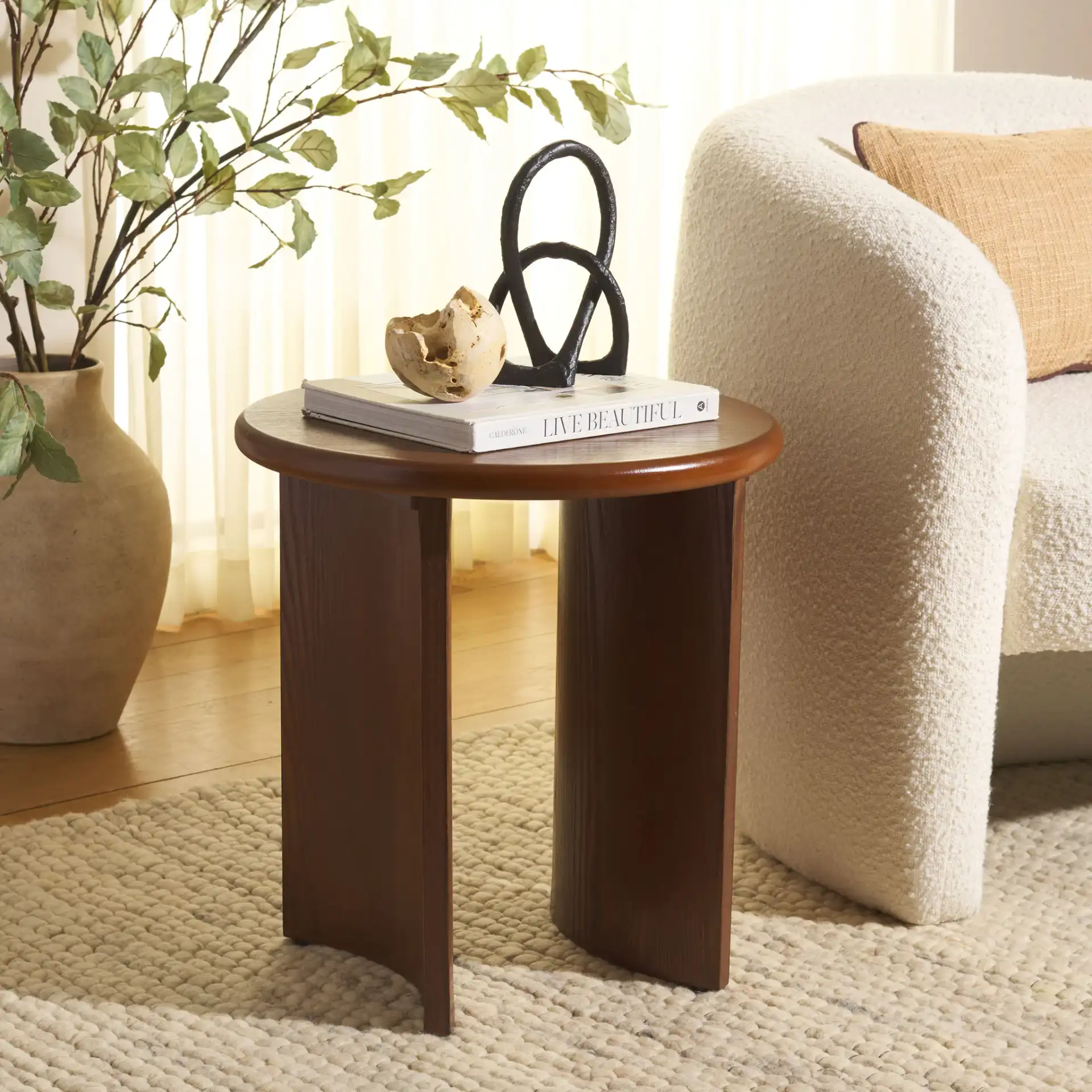 Alanka Round End Table in Black in a styled room