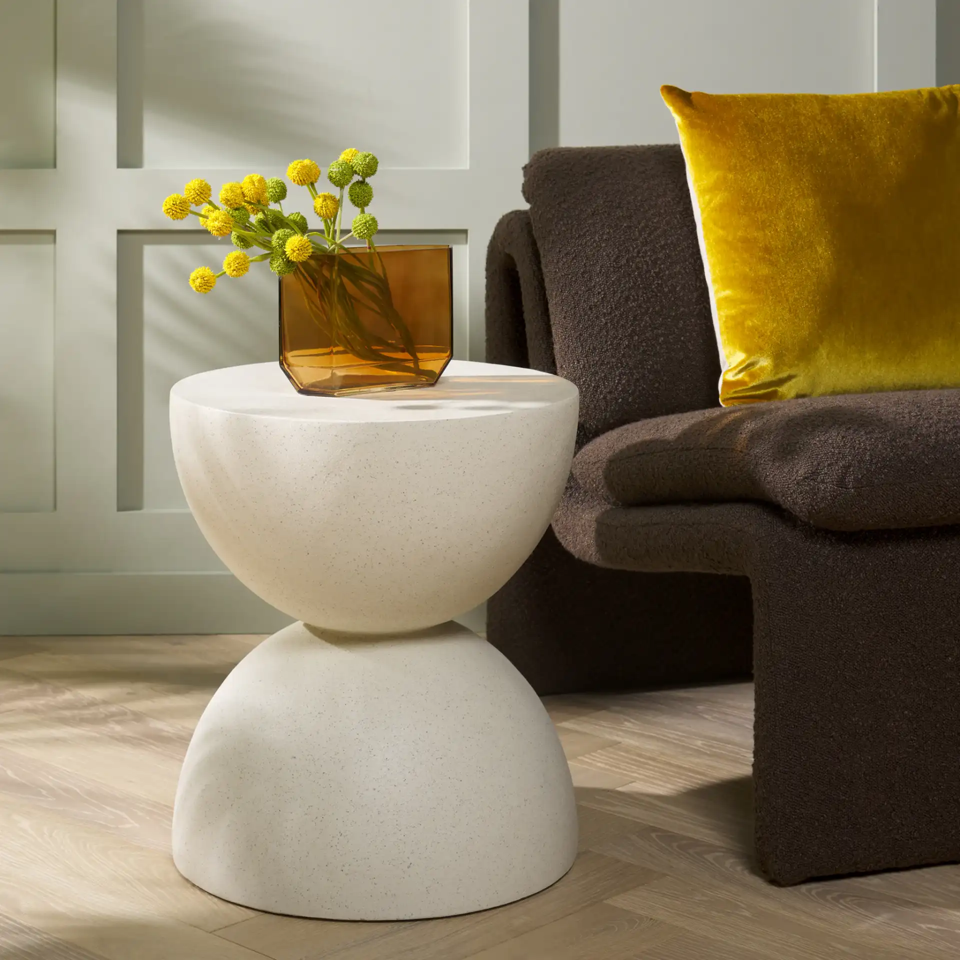 Austyn Hourglass Accent Table in White in a styled room
