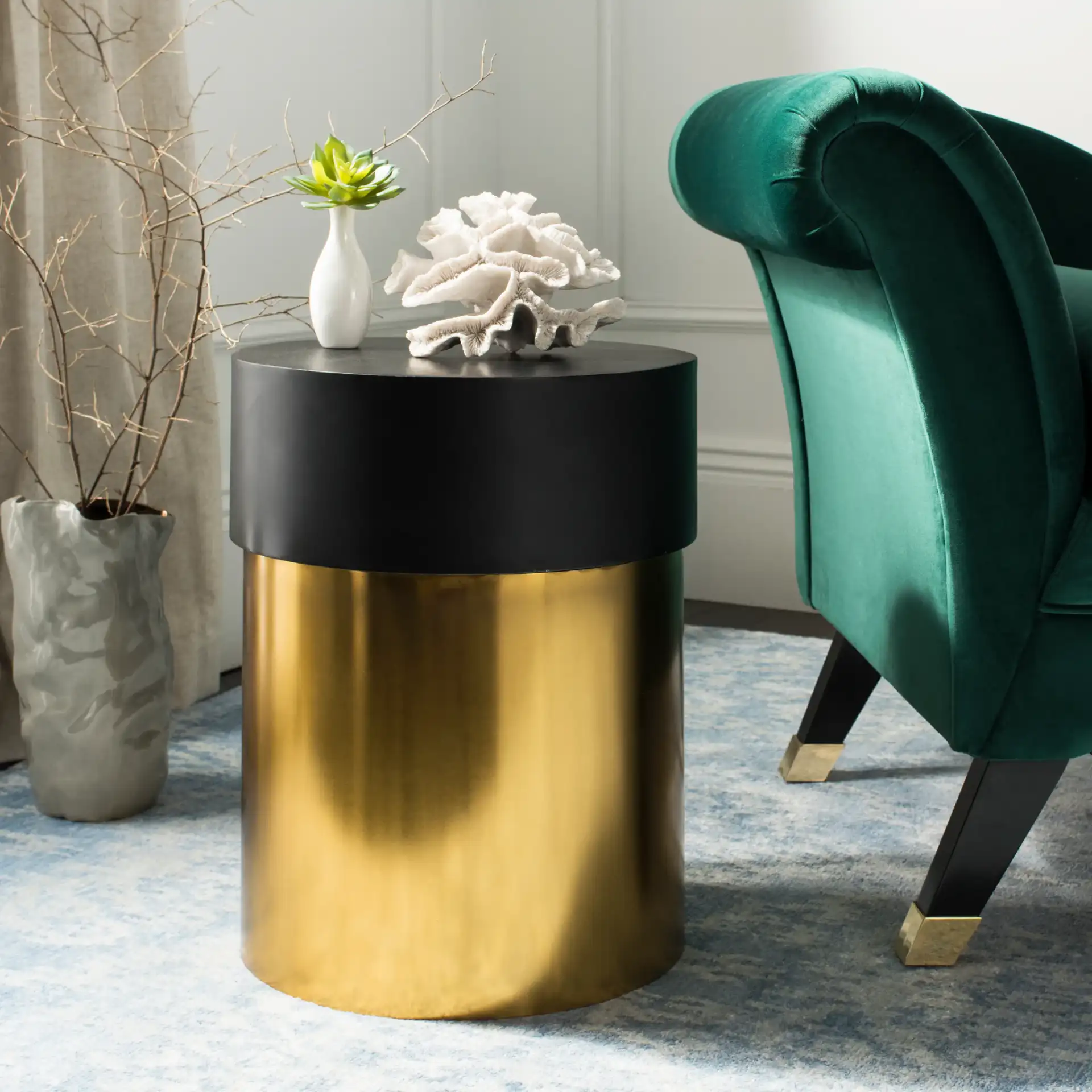 Solstice Round Side Table in Black / Gold in a styled room