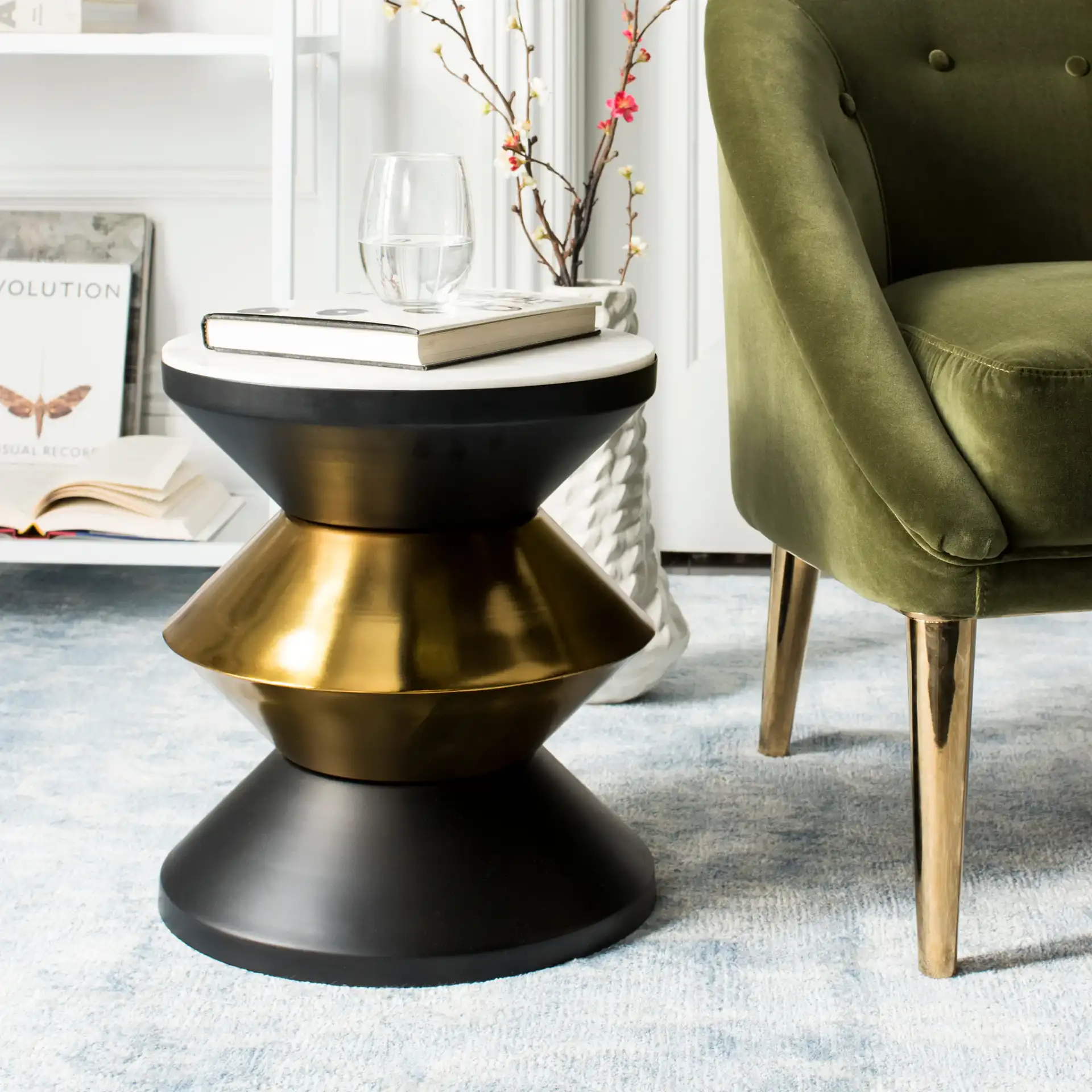 Azizi Stone Top Side Table in Black / Gold / White in a styled room