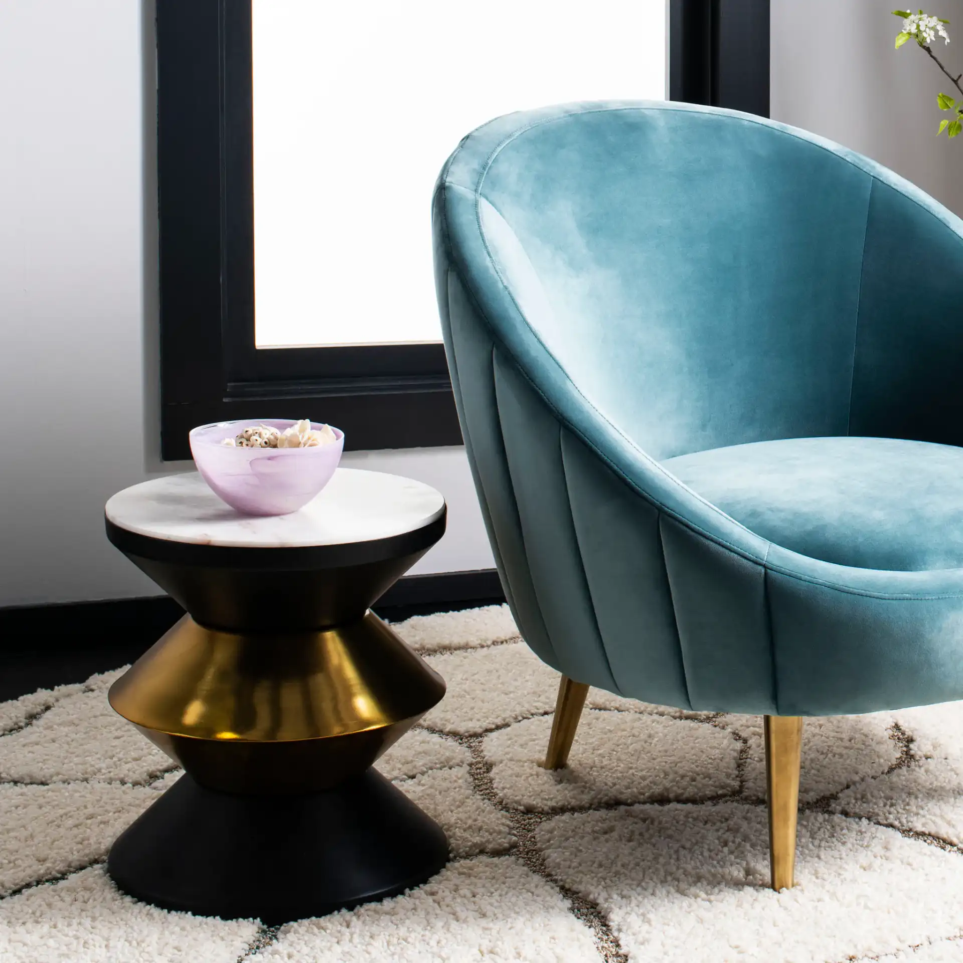 Azizi Stone Top Side Table in Black / Gold / White in a styled room