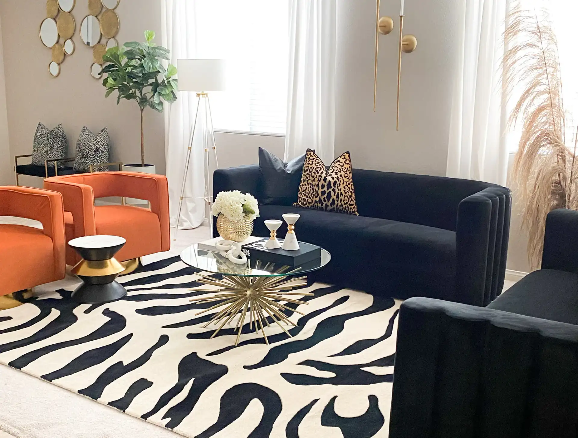 Azizi Stone Top Side Table in Black / Gold / White in a styled room