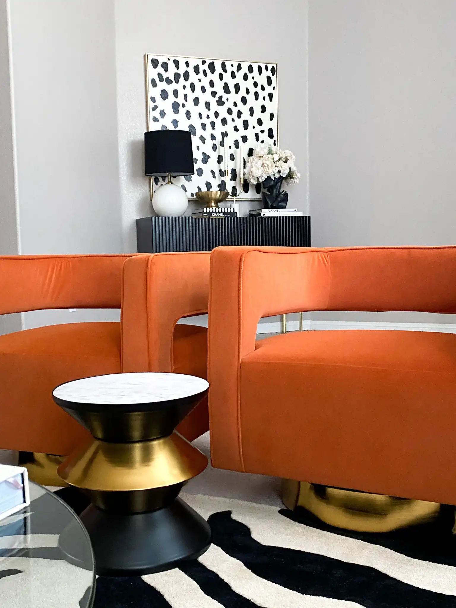 Azizi Stone Top Side Table in Black / Gold / White in a styled room