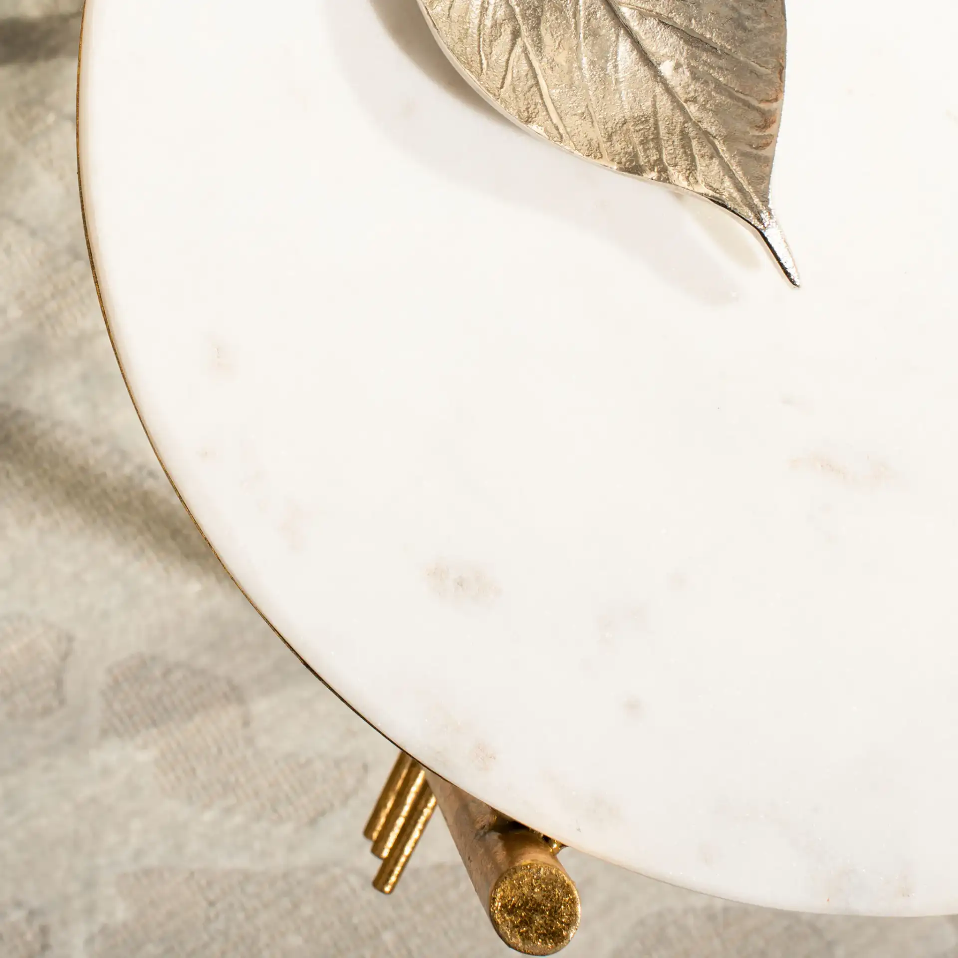 Jenesis Round Accent Table in White Marble / Gold in a styled room