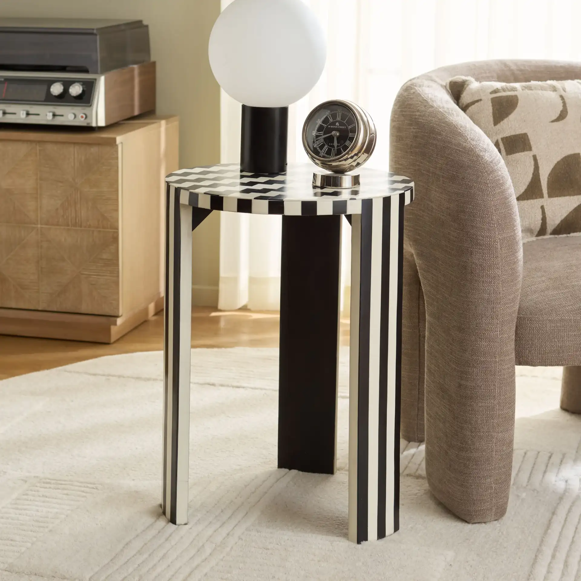 Rinna Accent Table in Black / White in a styled room