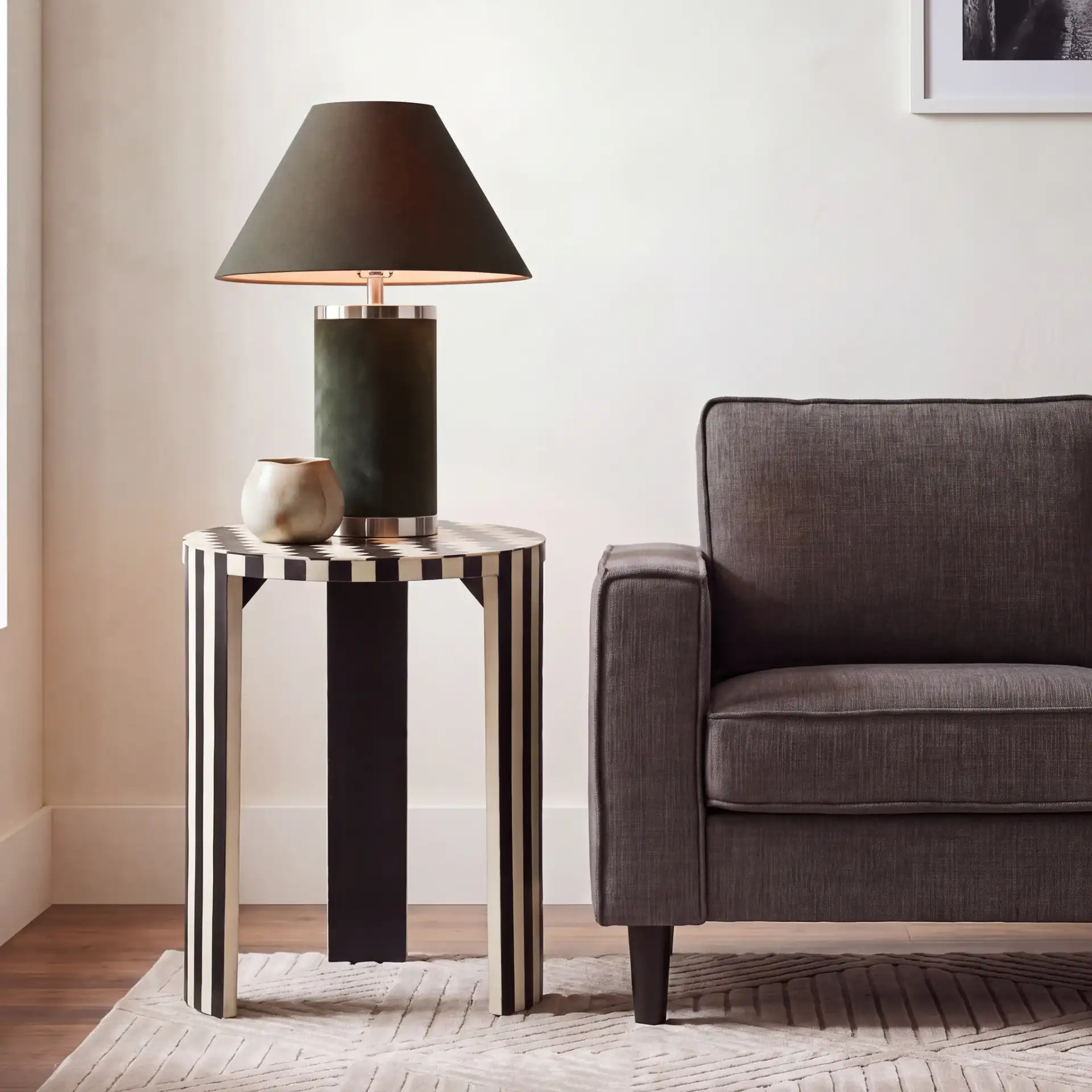 Rinna Accent Table in Black / White in a styled room