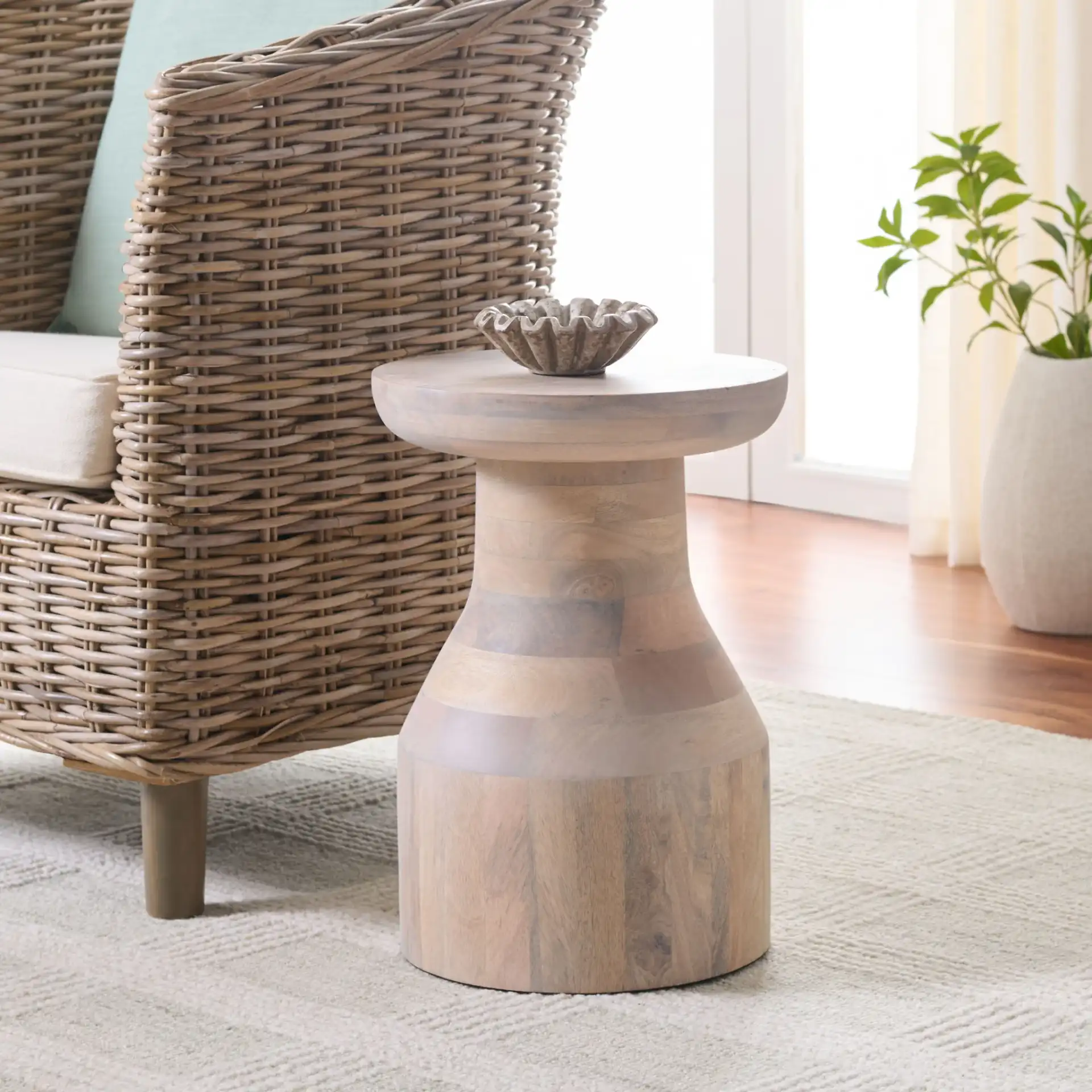 Nestor Round Accent Table in White Washed in a styled room