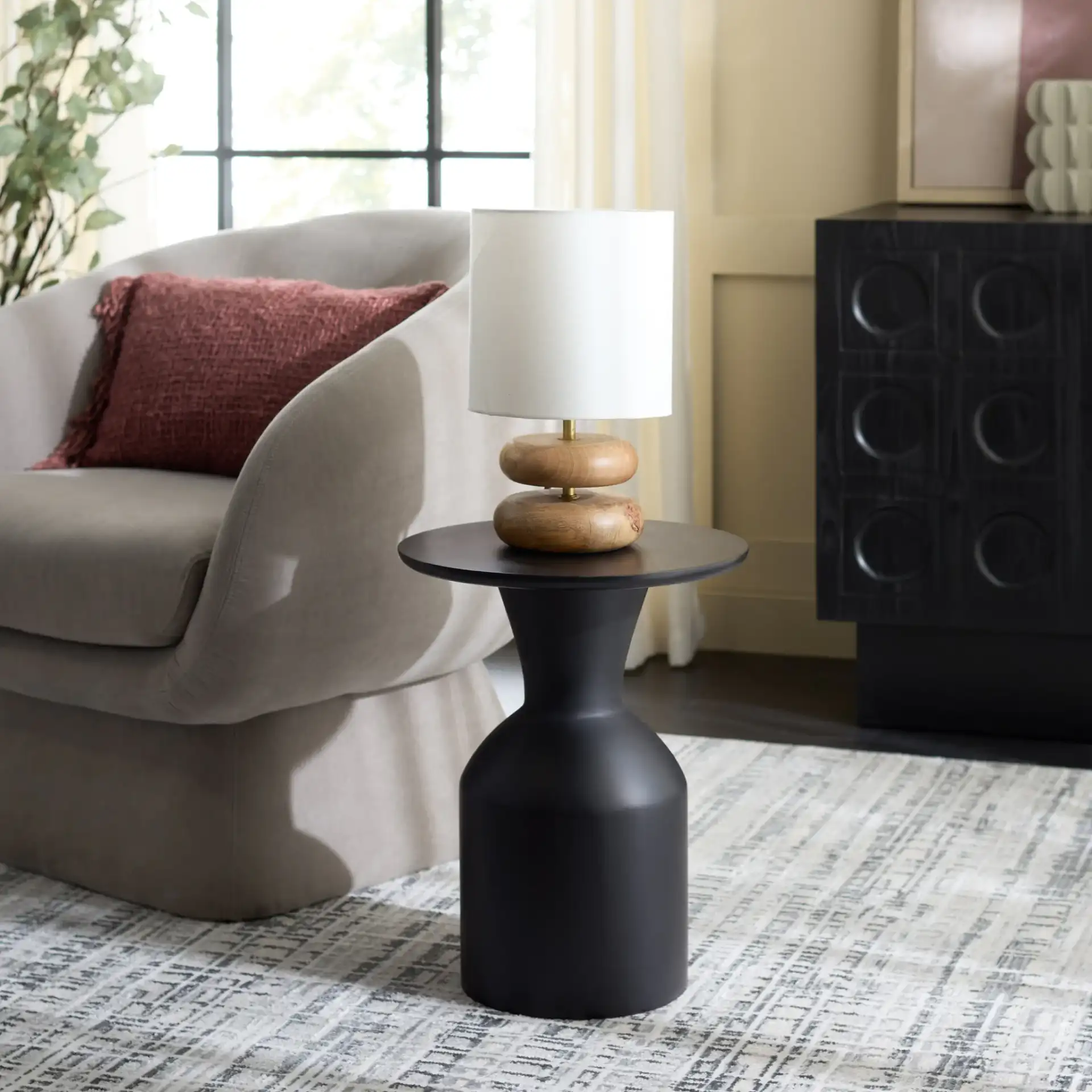 Tazon Round Accent Table in Black in a styled room