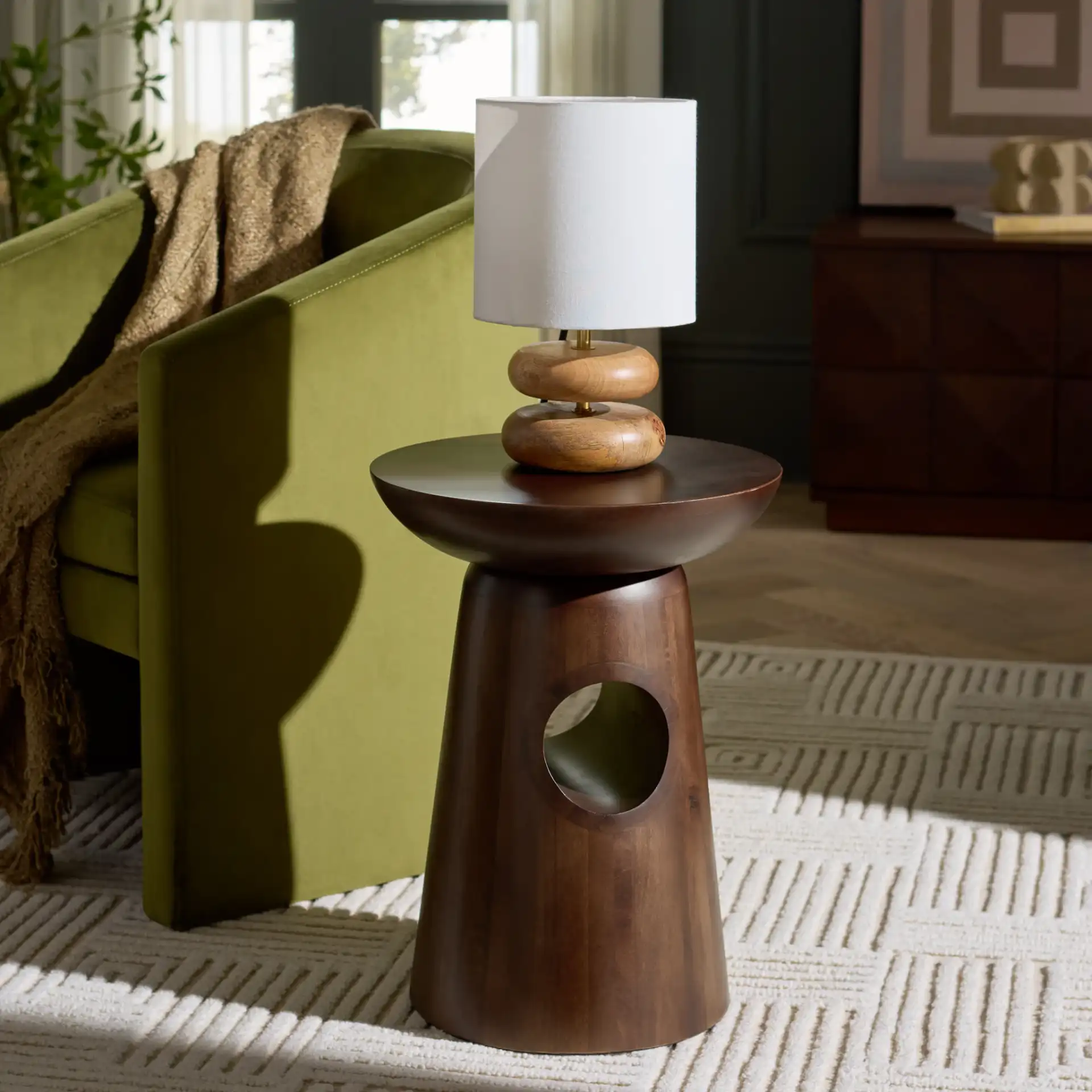 Zenon Round Accent Table in Dark Brown in a styled room