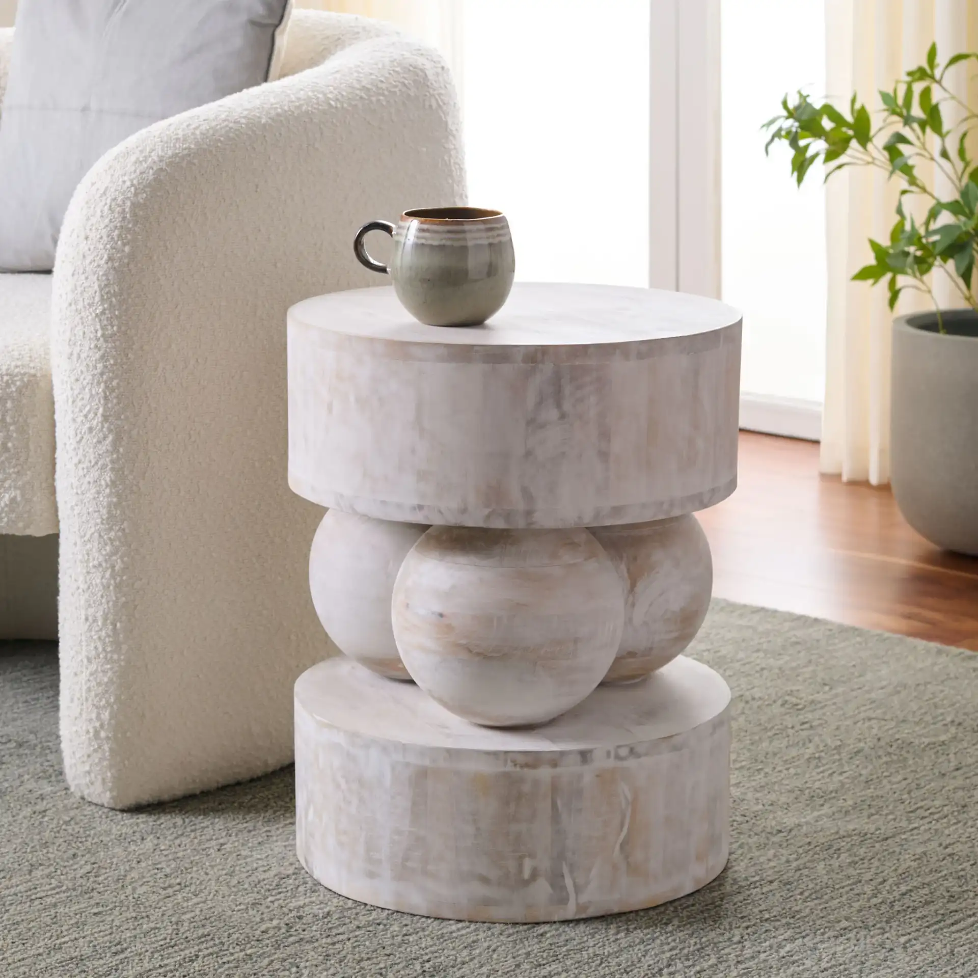 Xavier Round Accent Table in White Washed in a styled room