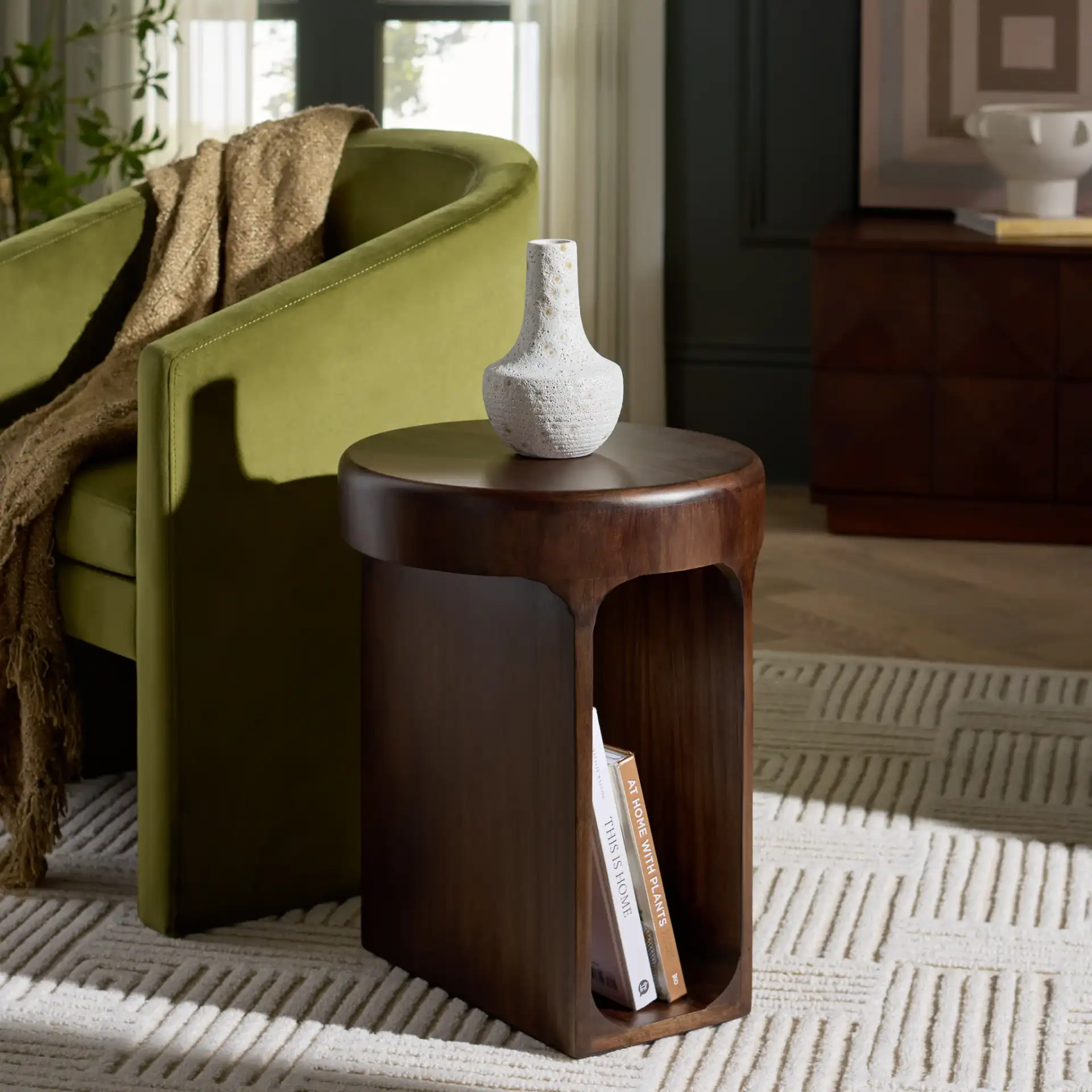Lobone Round Accent Table in Dark Brown in a styled room