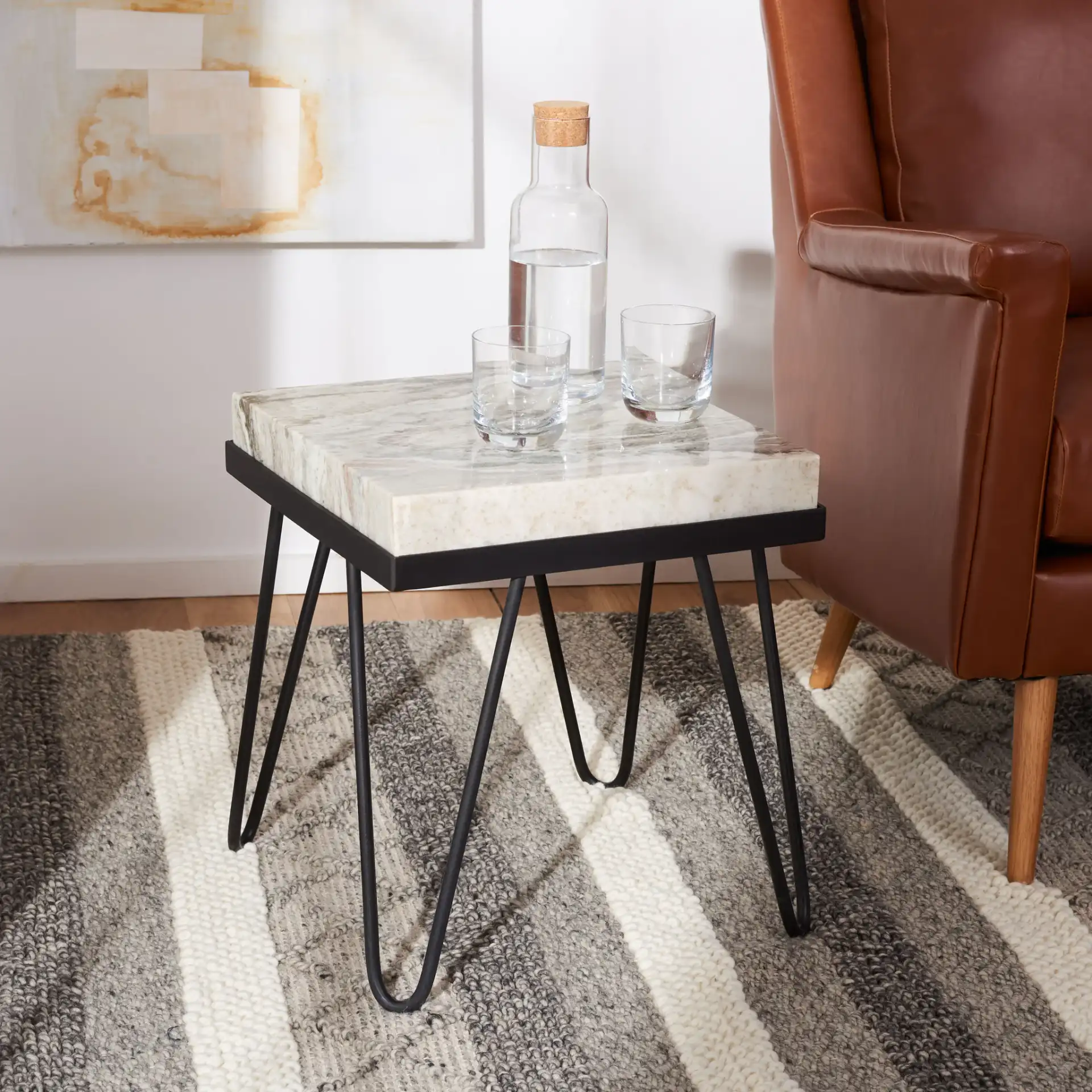 Jada Stone Top Accent Table in Multicolor Gray Stone / Black in a styled room