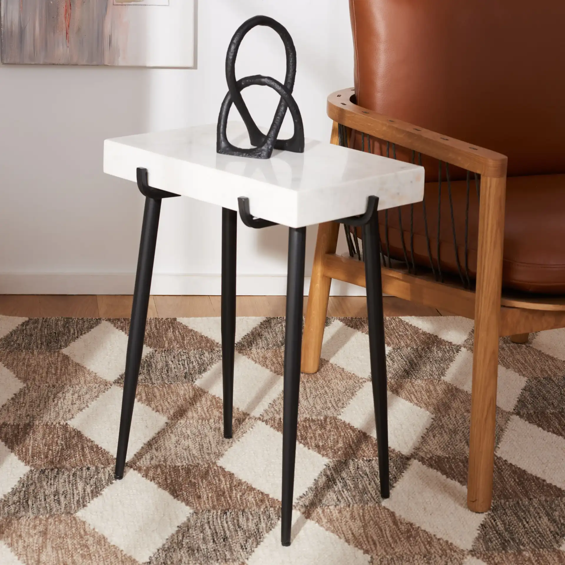 Yuki Stone Top Accent Table in White / Black in a styled room