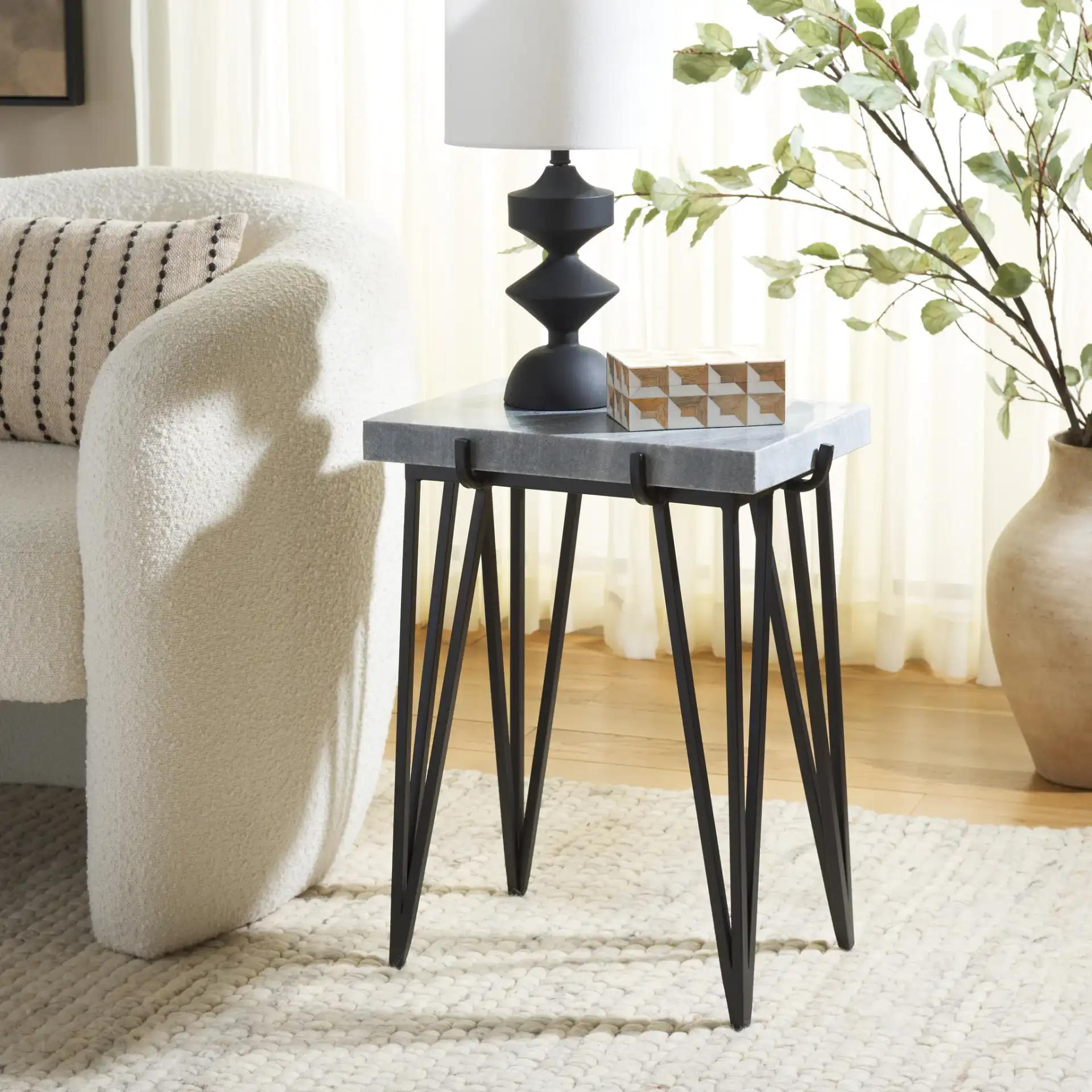 Rolf Marble Side Table in Gray White / Black in a styled room