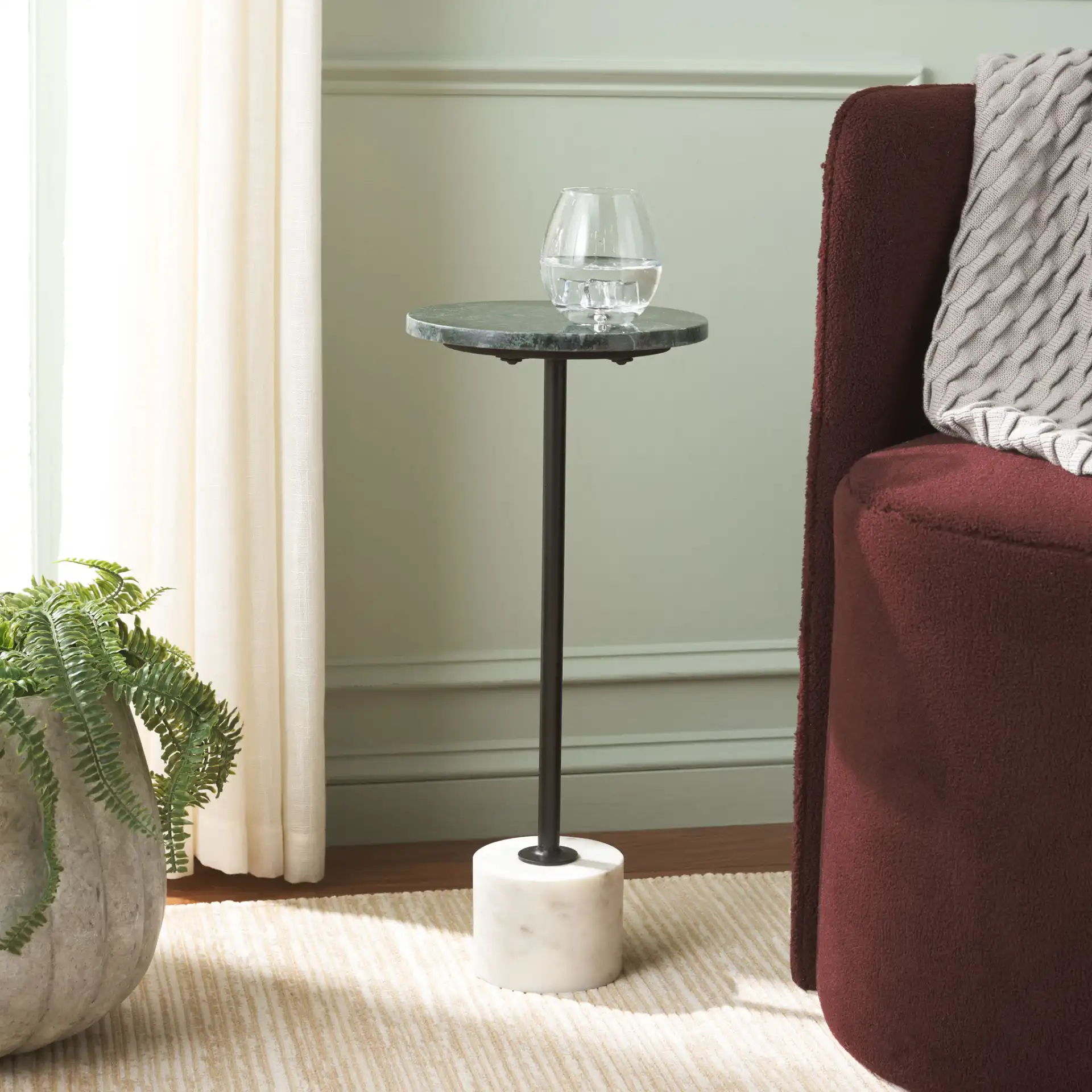 Karik Round Side Table in Dark Green / Black in a styled room