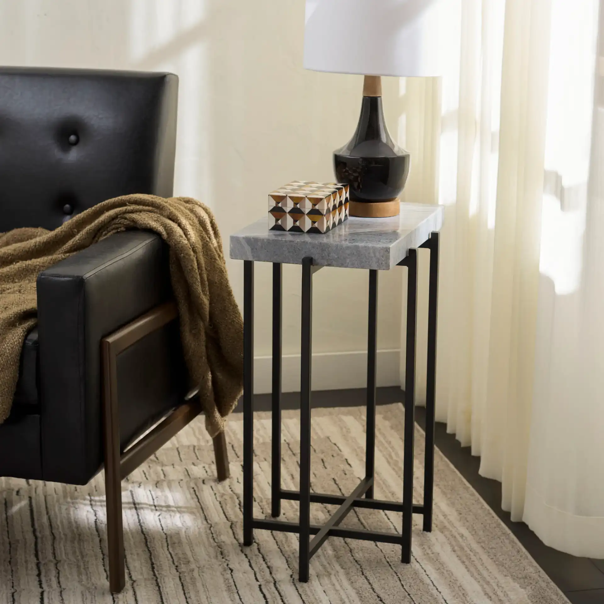Aloha Marble Side Table in Gray / Black in a styled room