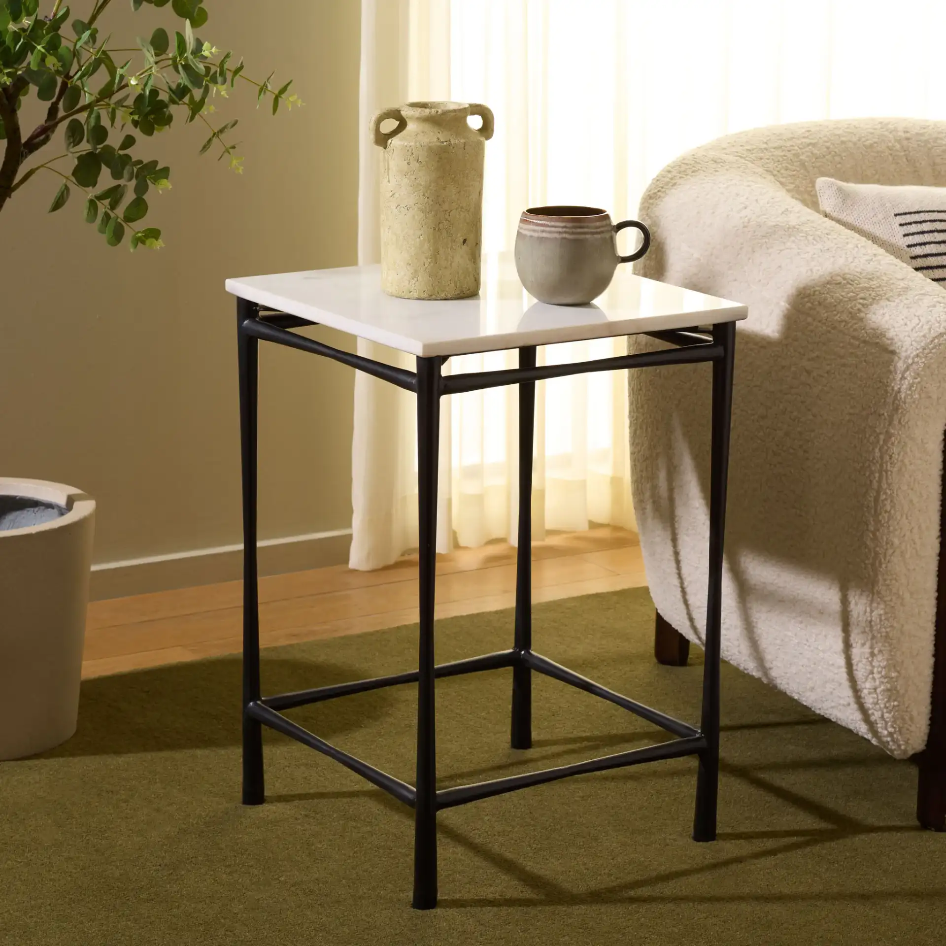 Nadezhda Marble Accent Table in White / Black in a styled room