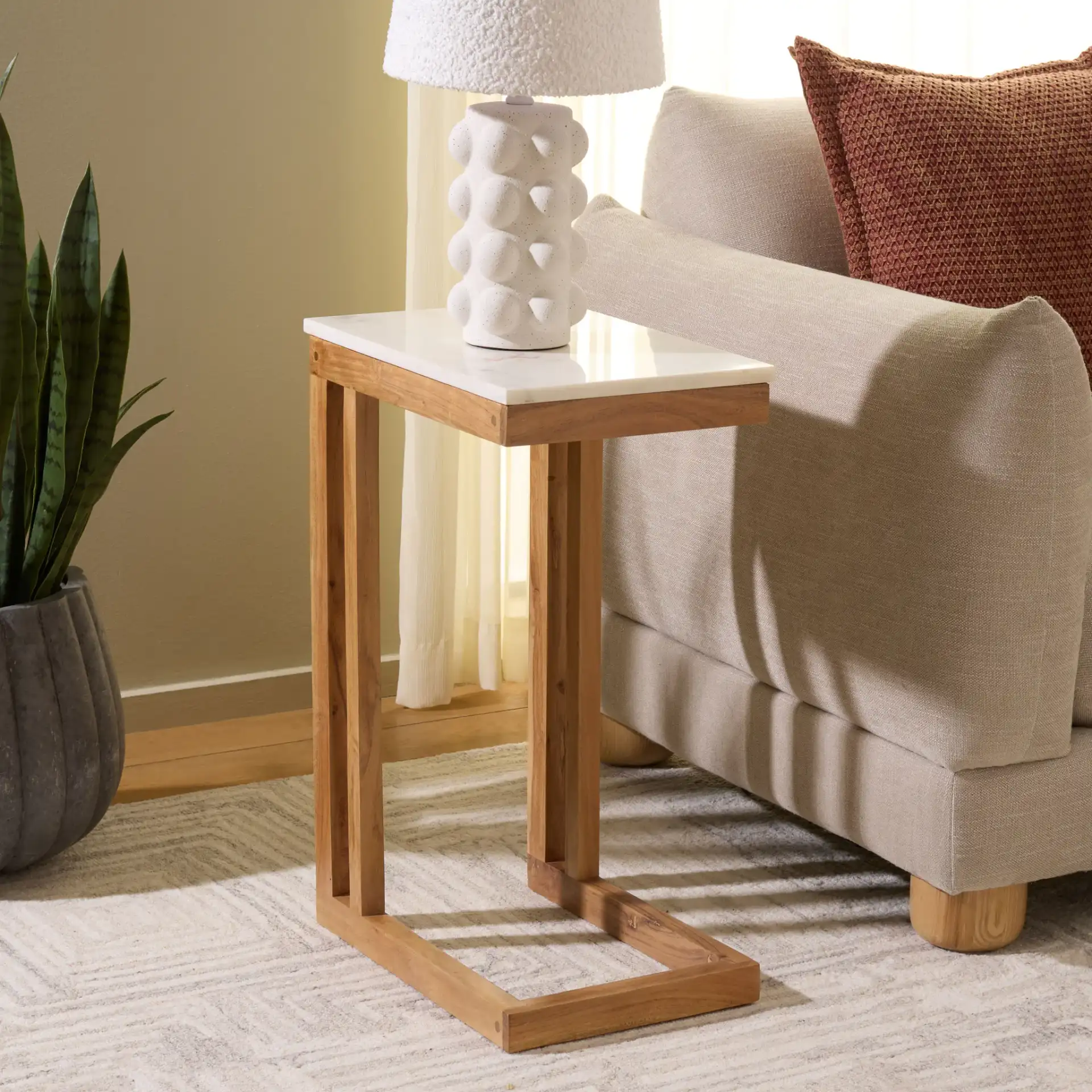 Zinaida Marble Accent Table in White / Natural in a styled room