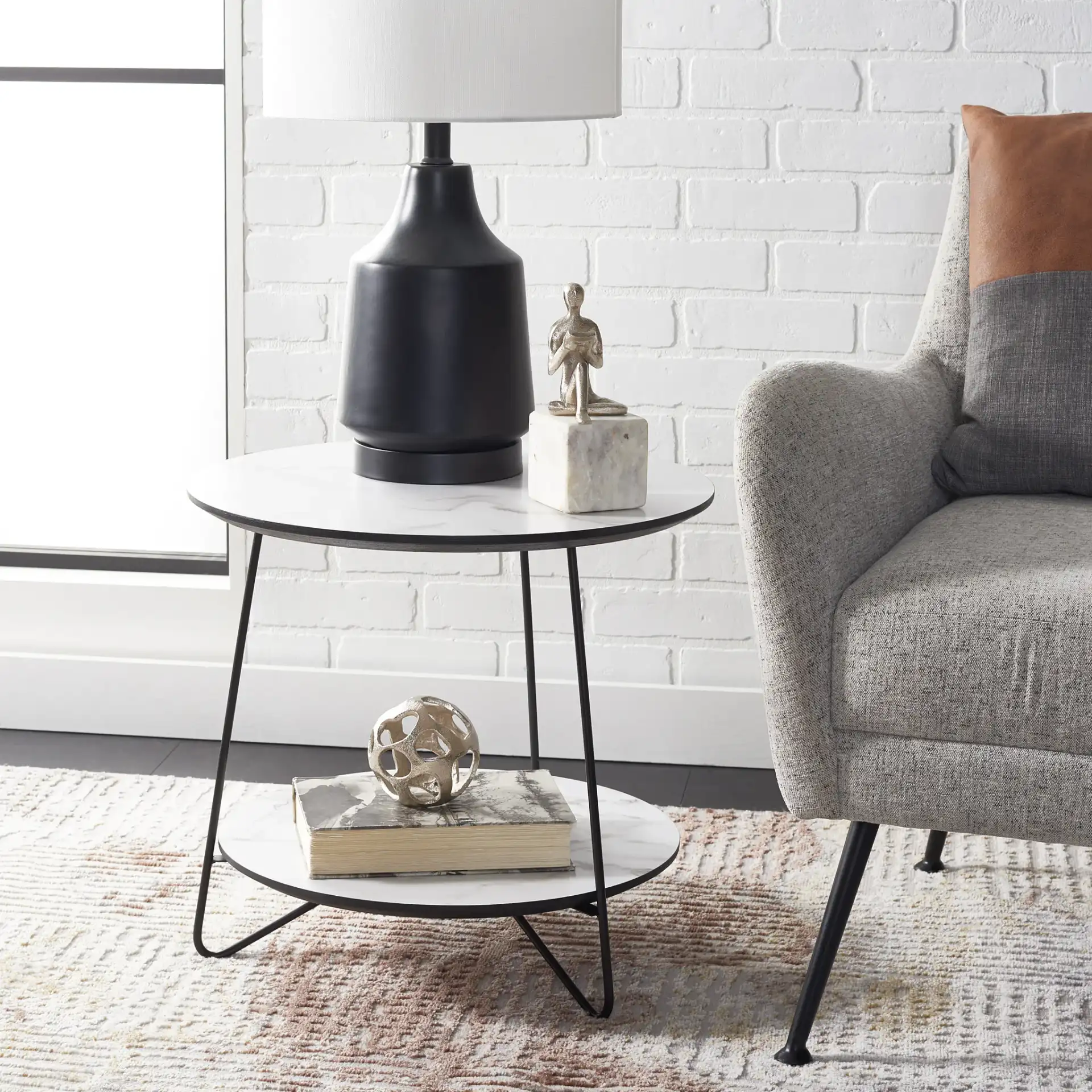 Avani Round Side Table in White / Black in a styled room