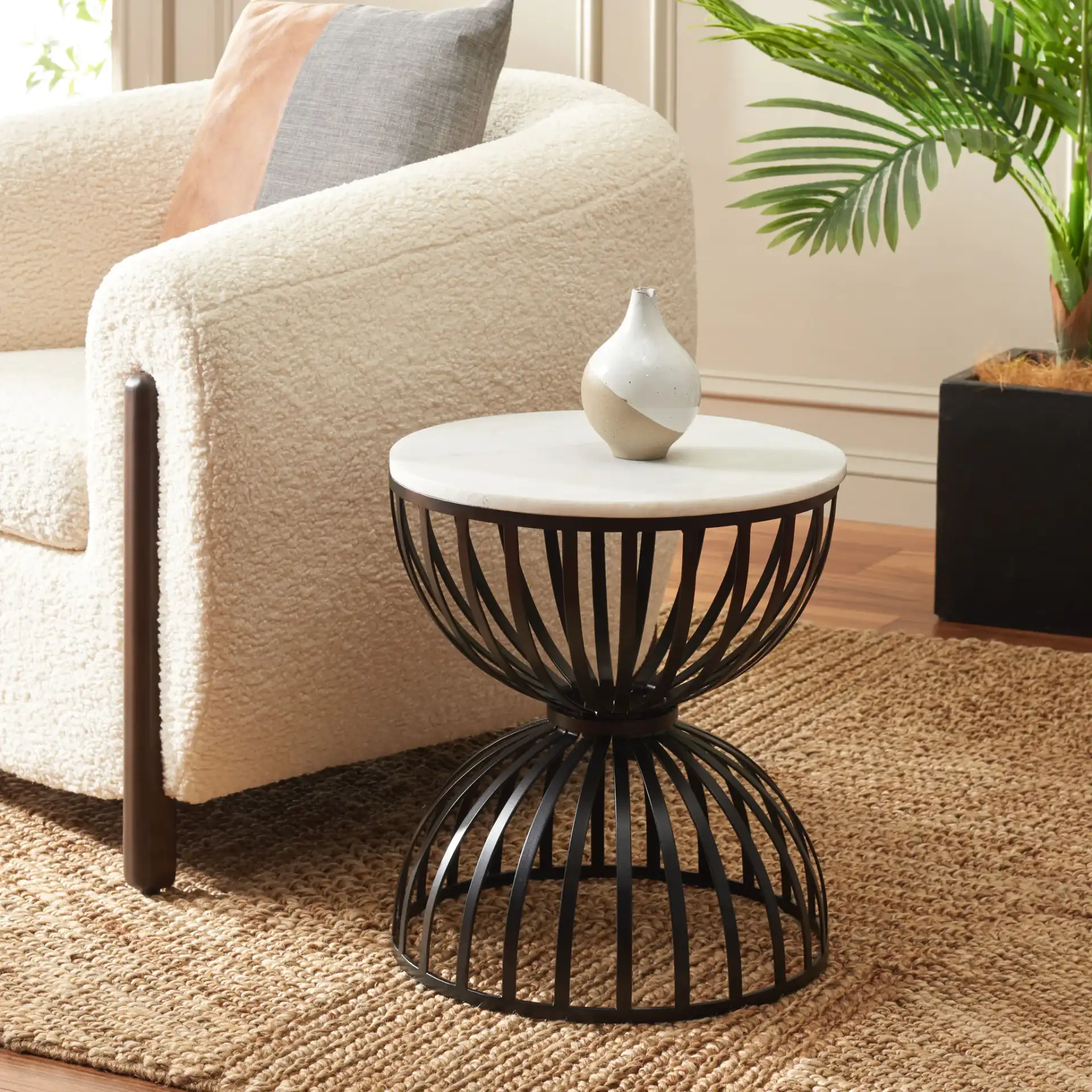 Tissaia Round Accent Table in White Marble / Black in a styled room