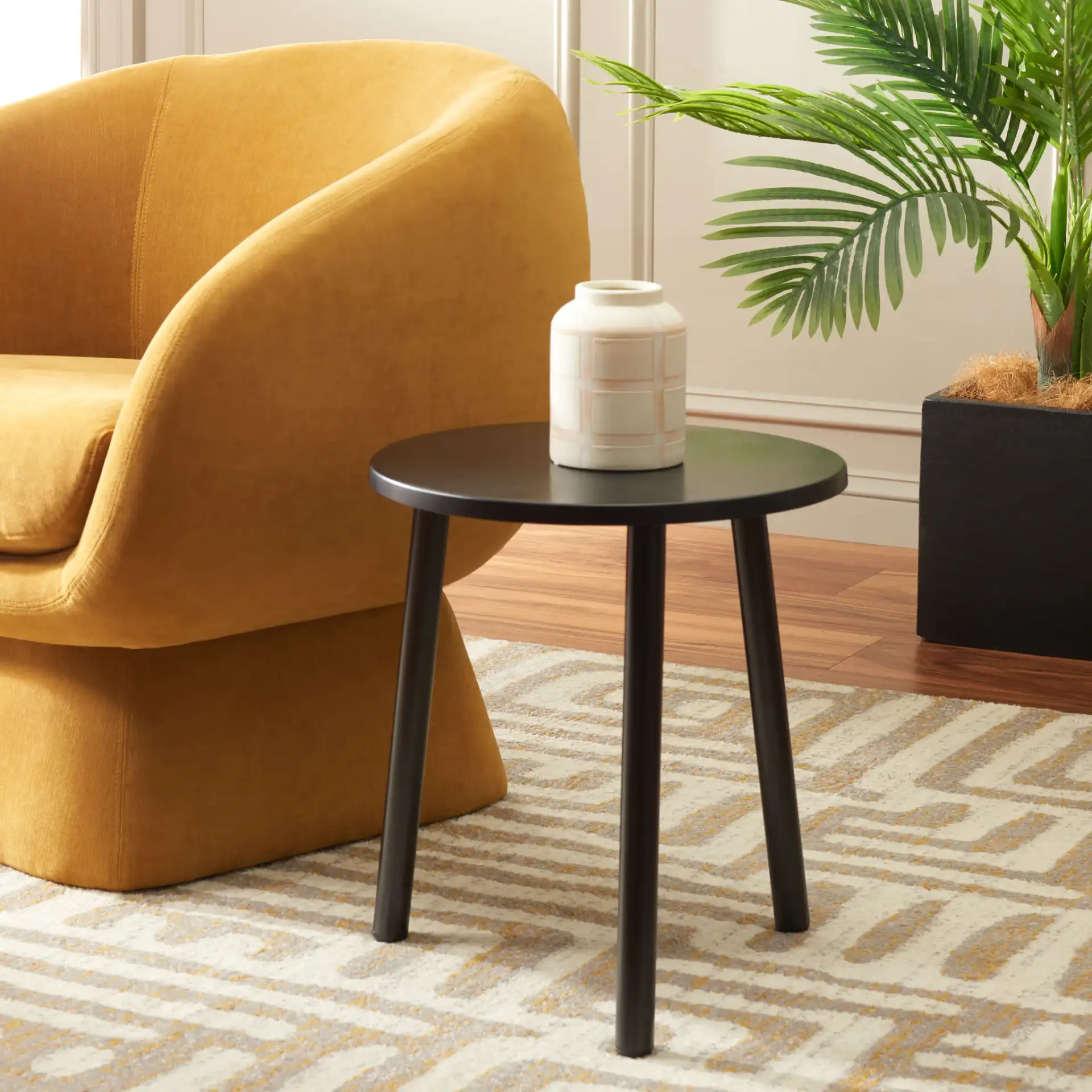 Ivitrio Round Accent Table in Black in a styled room