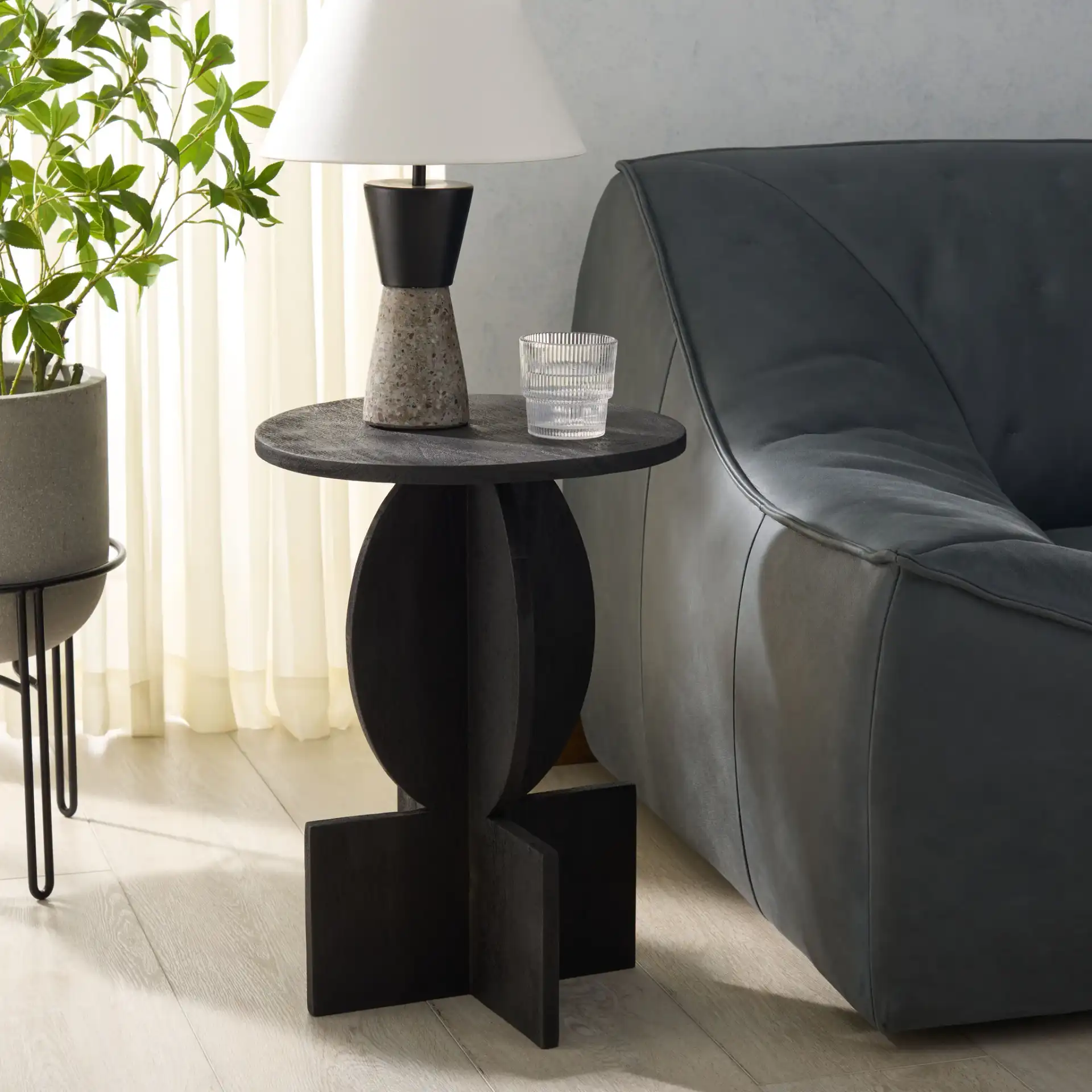 Kamyar Accent Table in Black in a styled room