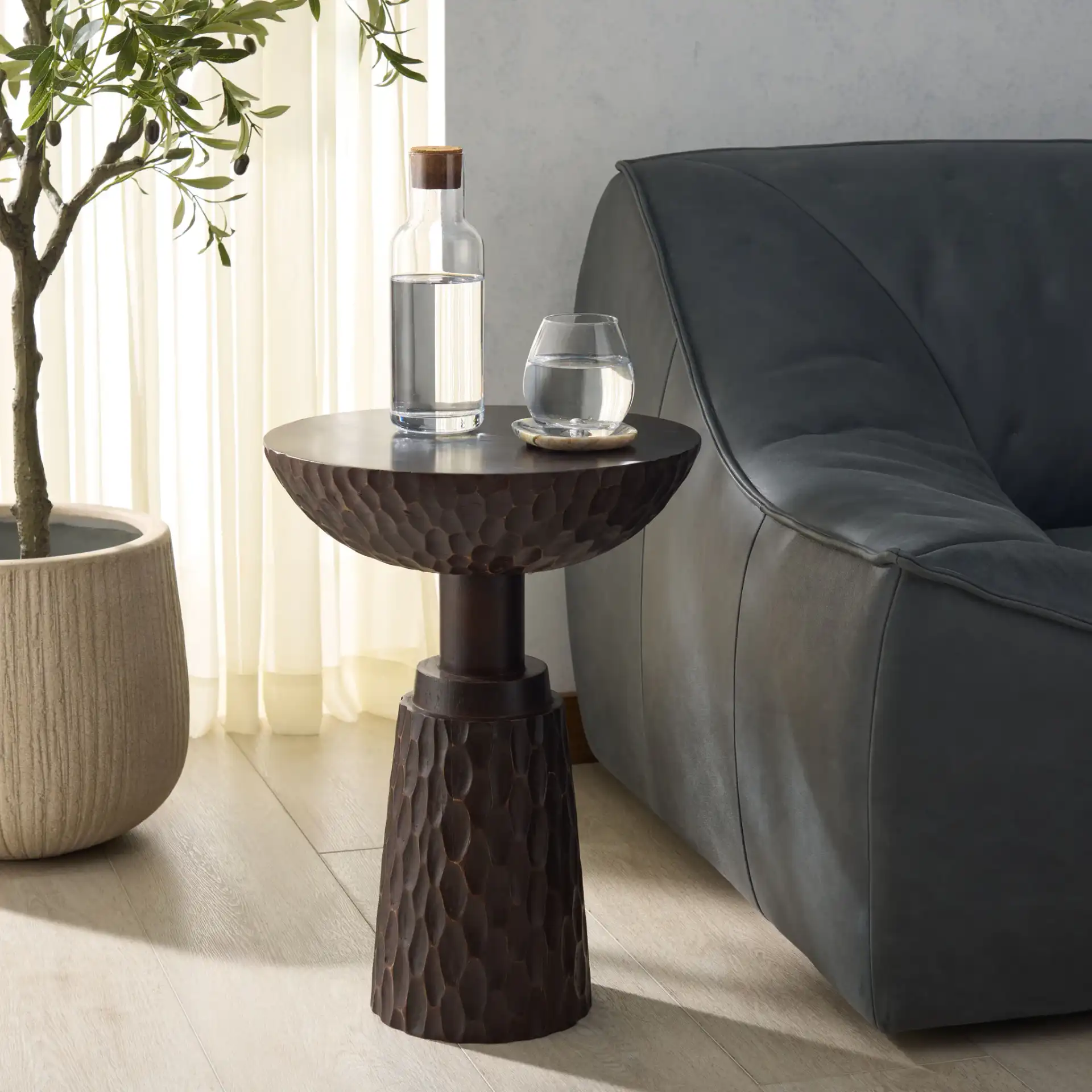 Mamanu Accent Table in Bronze in a styled room