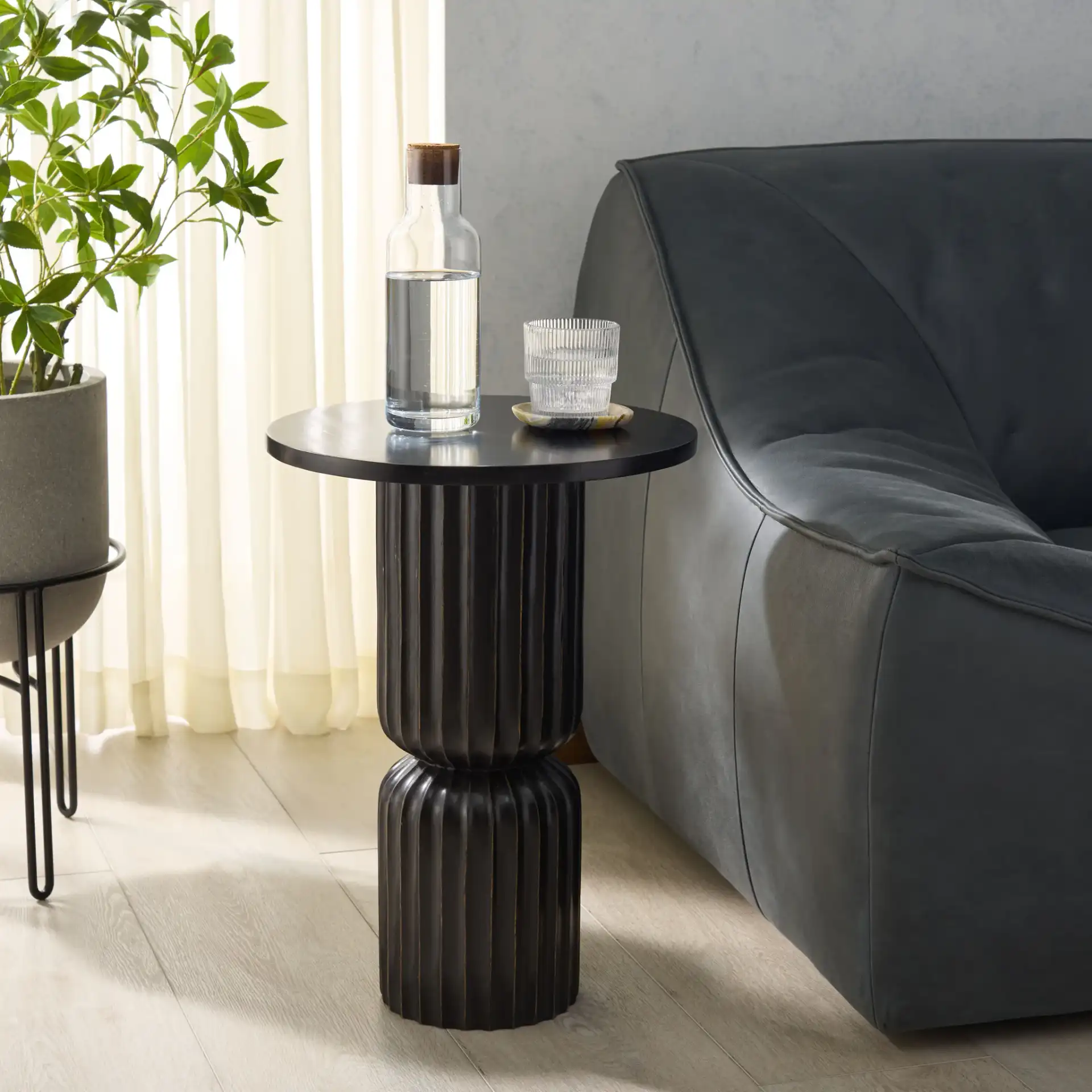 Yaseen Accent Table in Black in a styled room