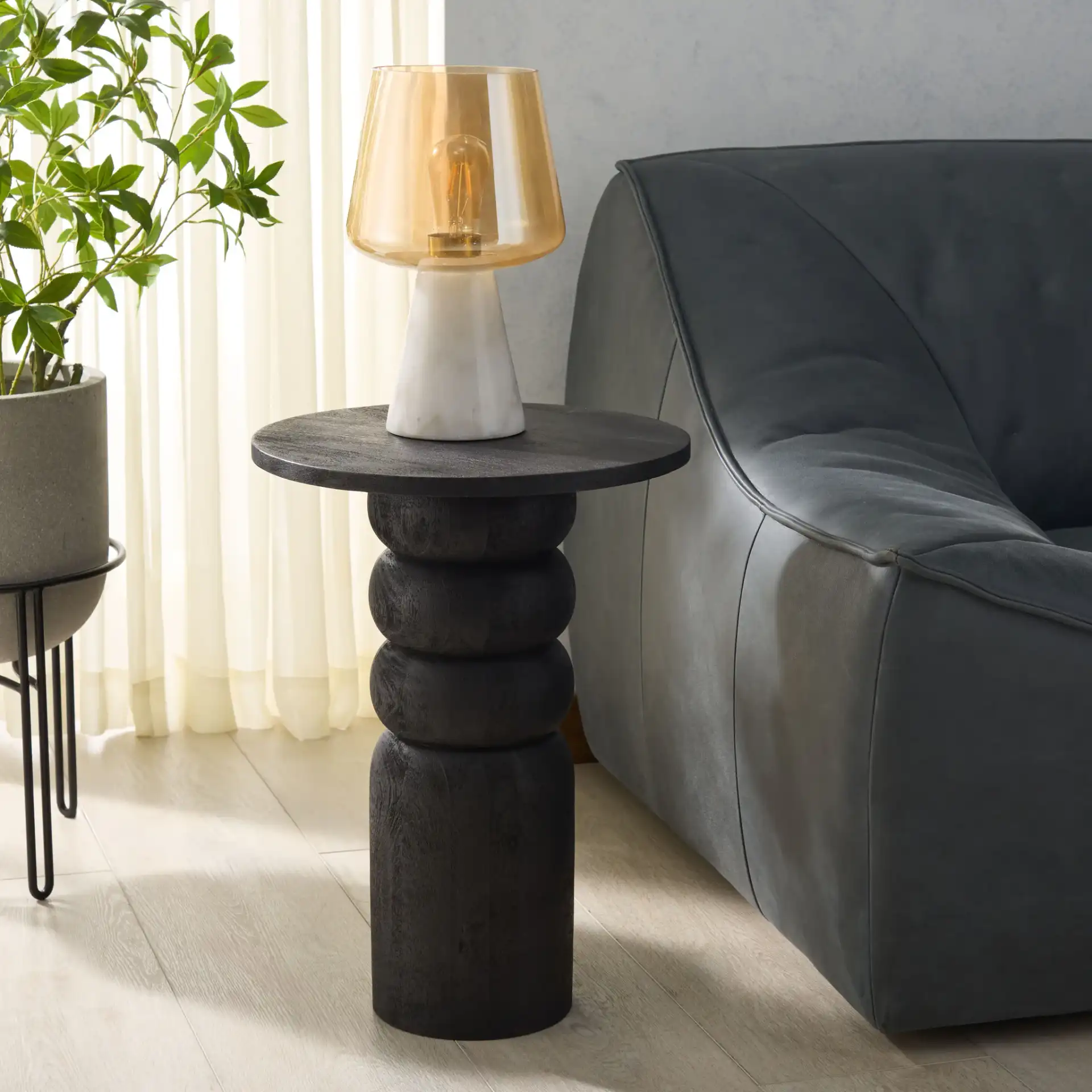 Janais Accent Table in Black in a styled room
