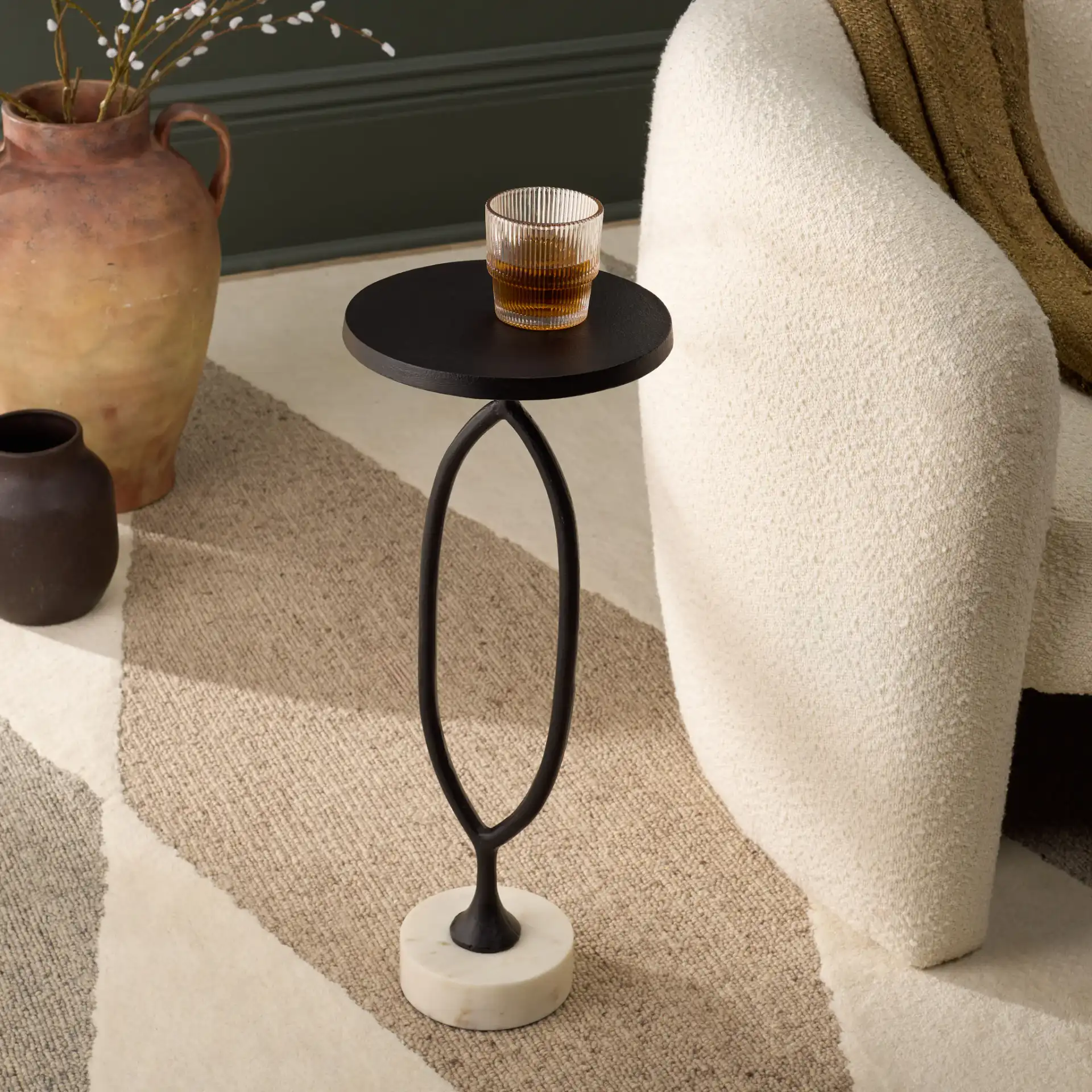 Malachy Side Table in Black / White in a styled room