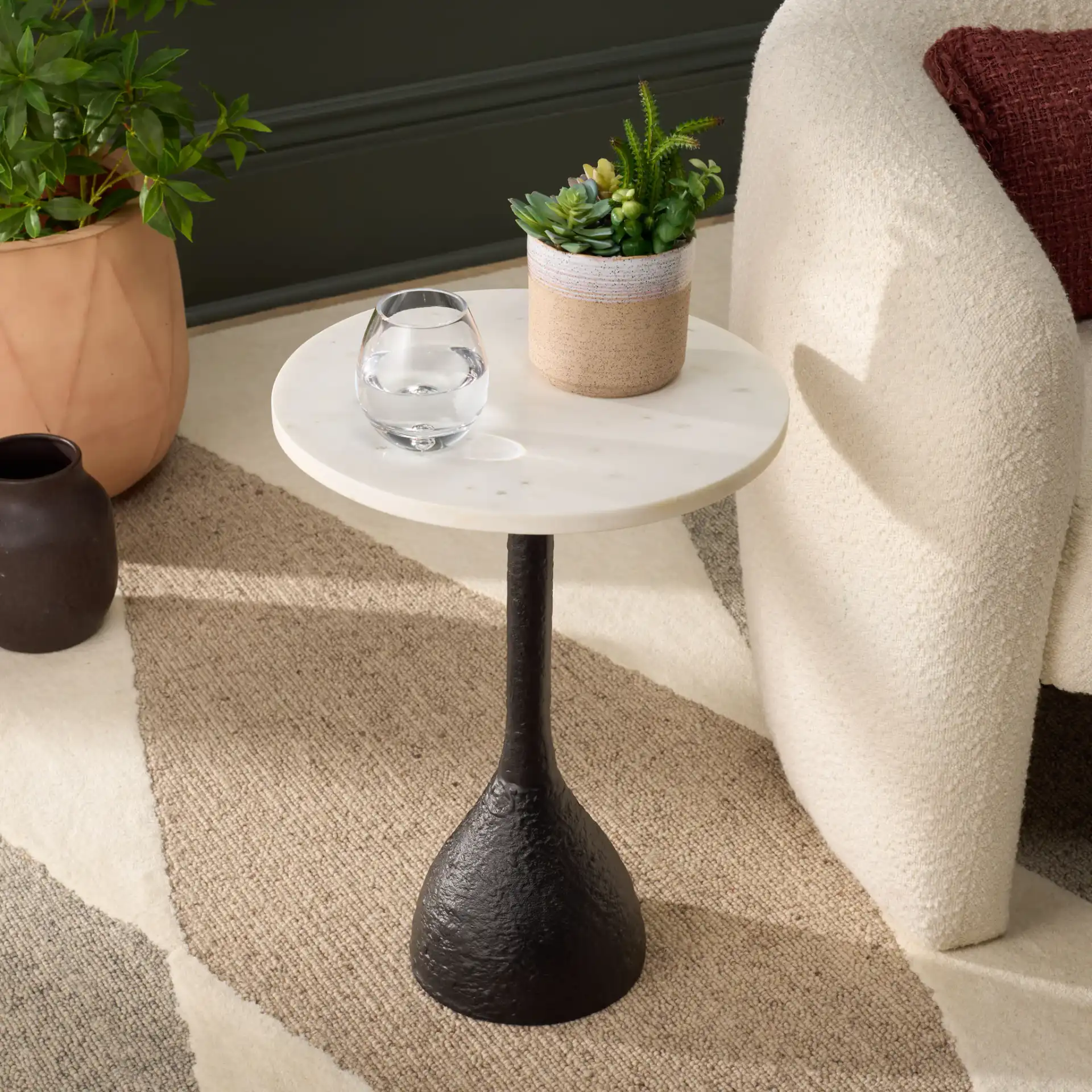 Avanni Side Table in Black / Ivory in a styled room