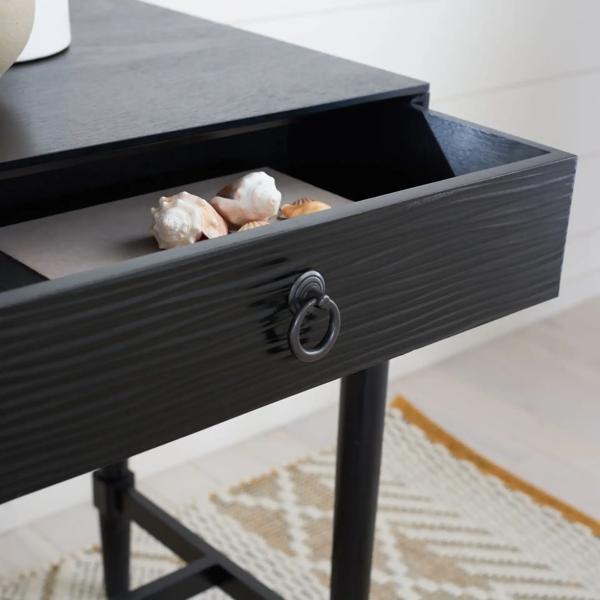 Mabel One-Drawer Accent Table in Black in a styled room